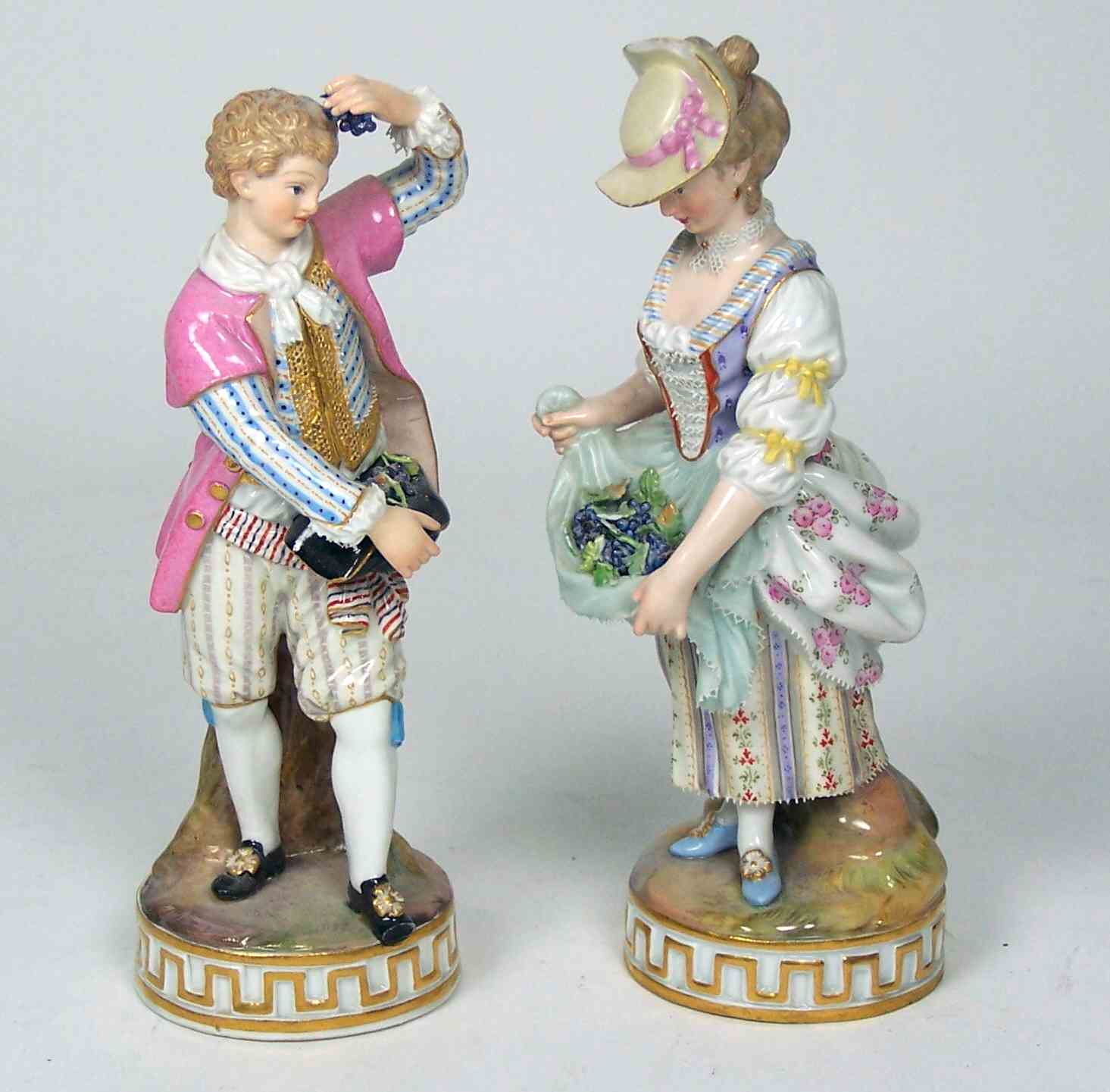 A pair of late 19th century Meissen figures of a boy and a girl