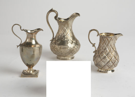 A Victorian silver milk jug and similar creamer