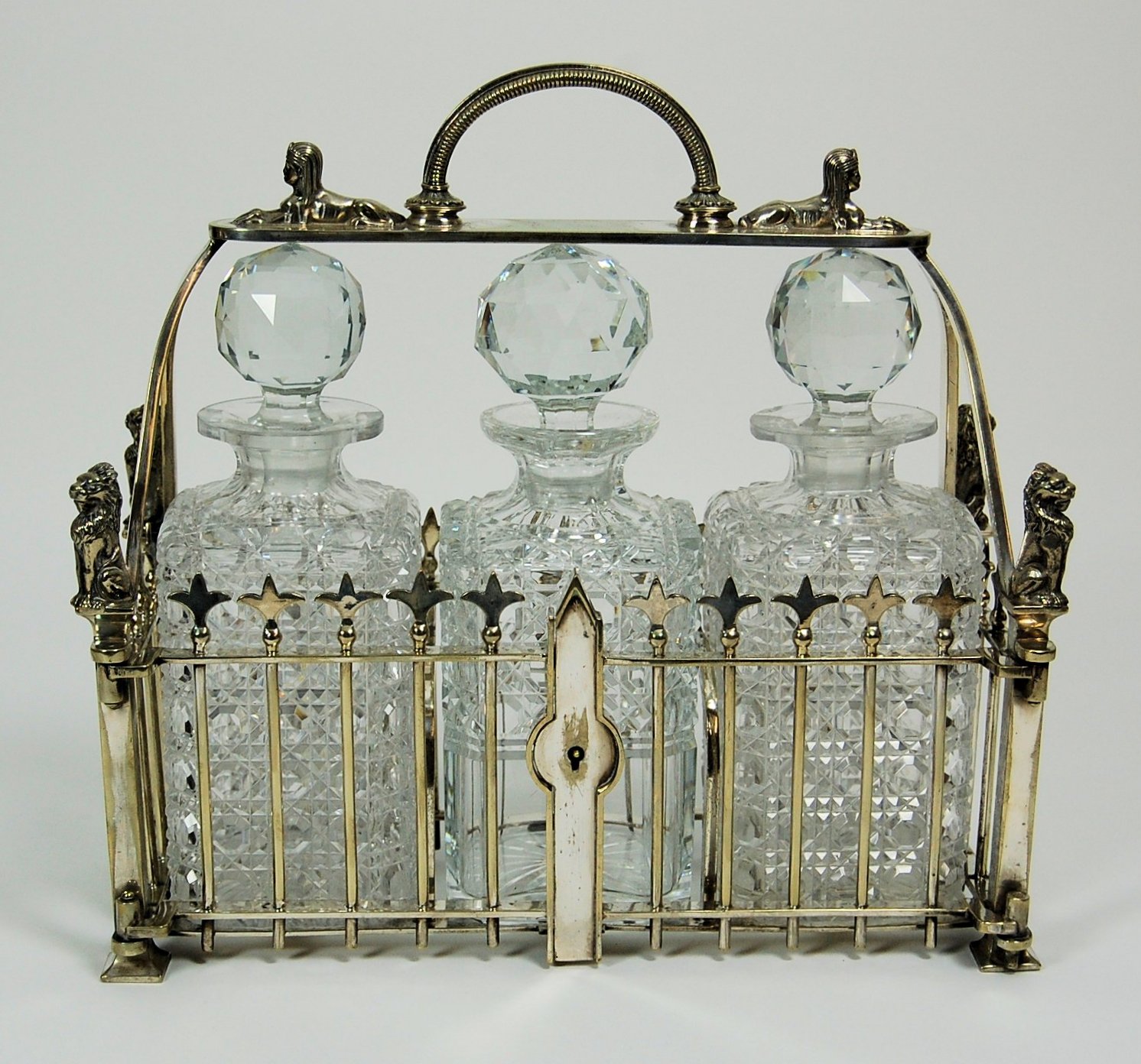 A silver plated three bottle tantalus