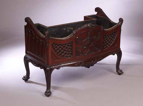 A carved mahogany jardinière