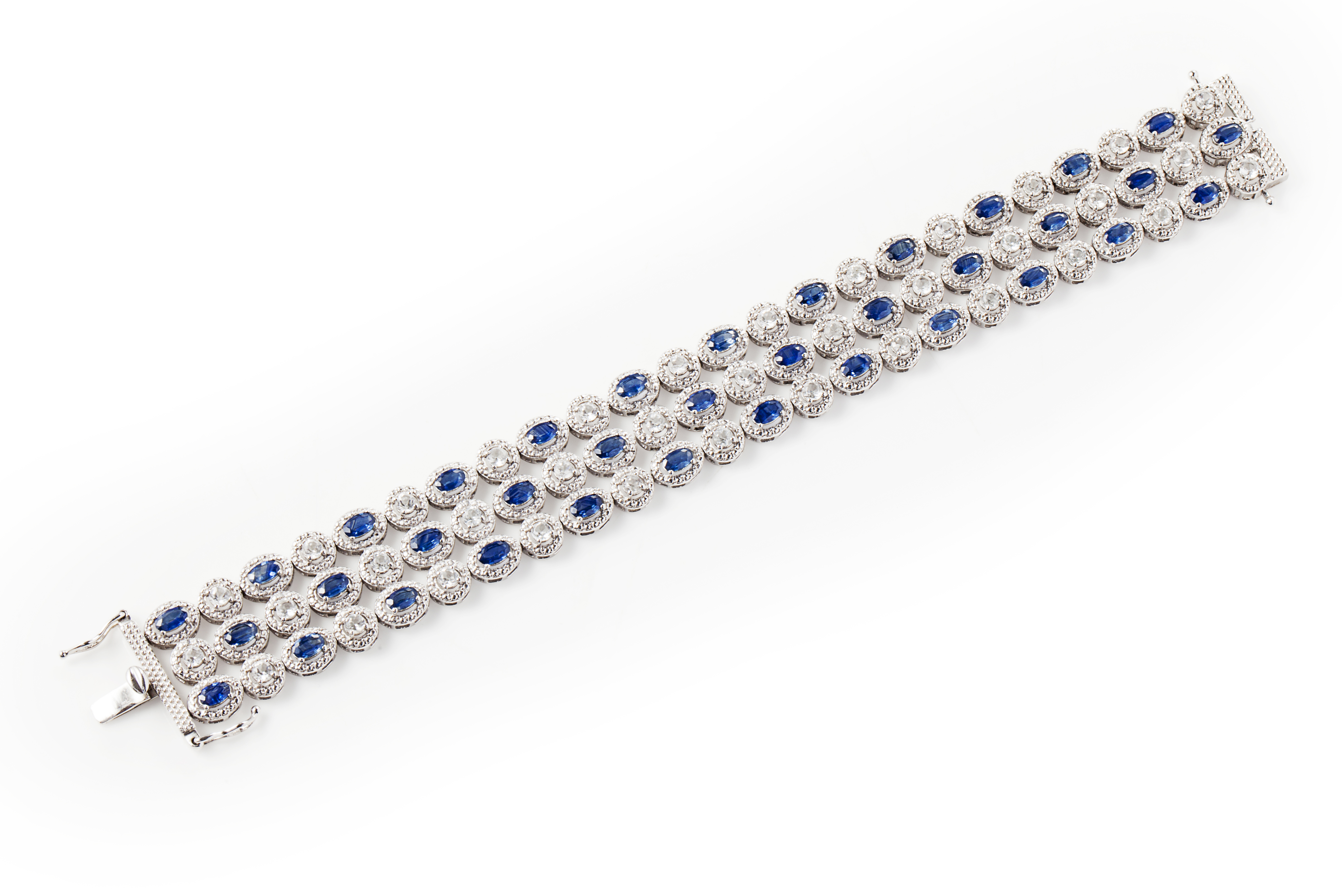 A sapphire and colourless gem set bracelet