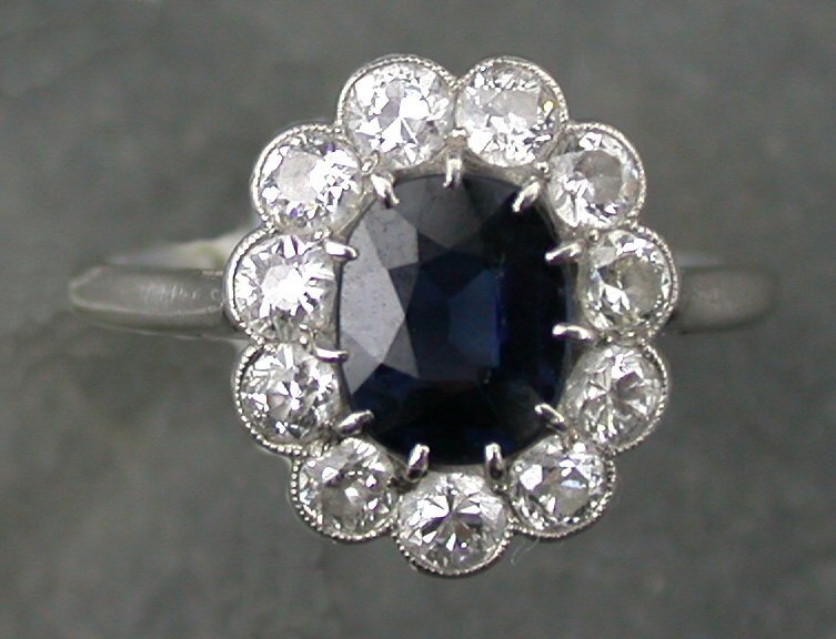 A platinum mounted sapphire and diamond cluster ring,