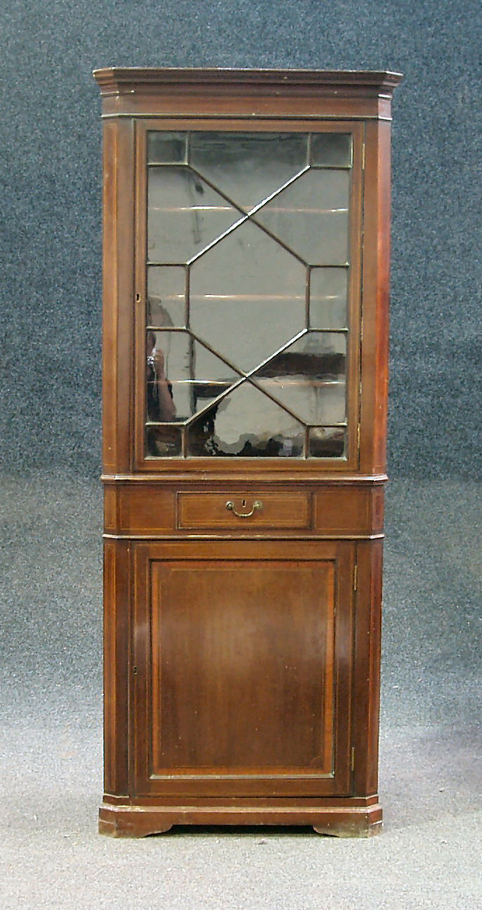 An Edwardian mahogany glazed corner cabinet