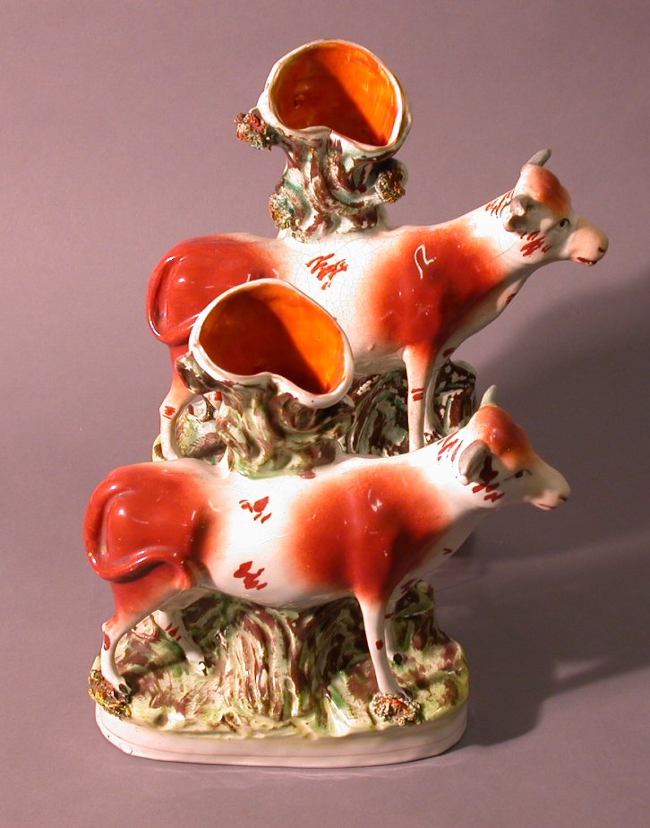 Two similar mid-19th century Staffordshire cow spill vases