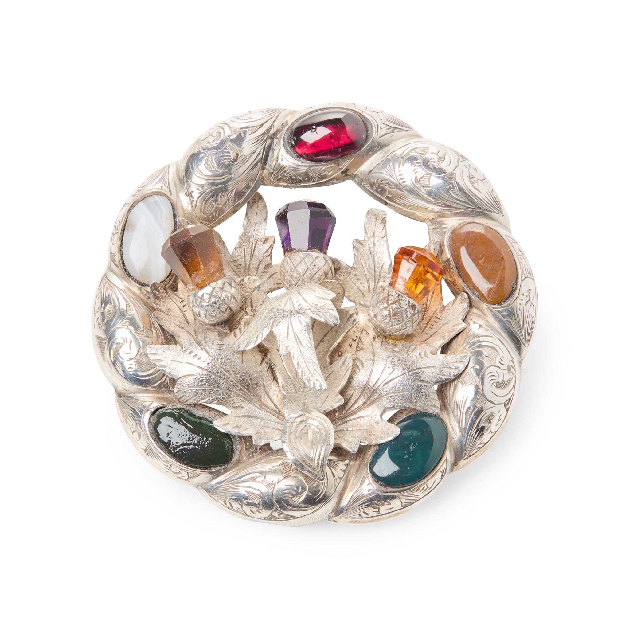 A LARGE VICTORIAN CITRINE AND HARDSTONE MOUNTED THISTLE ANNULAR BROOCH