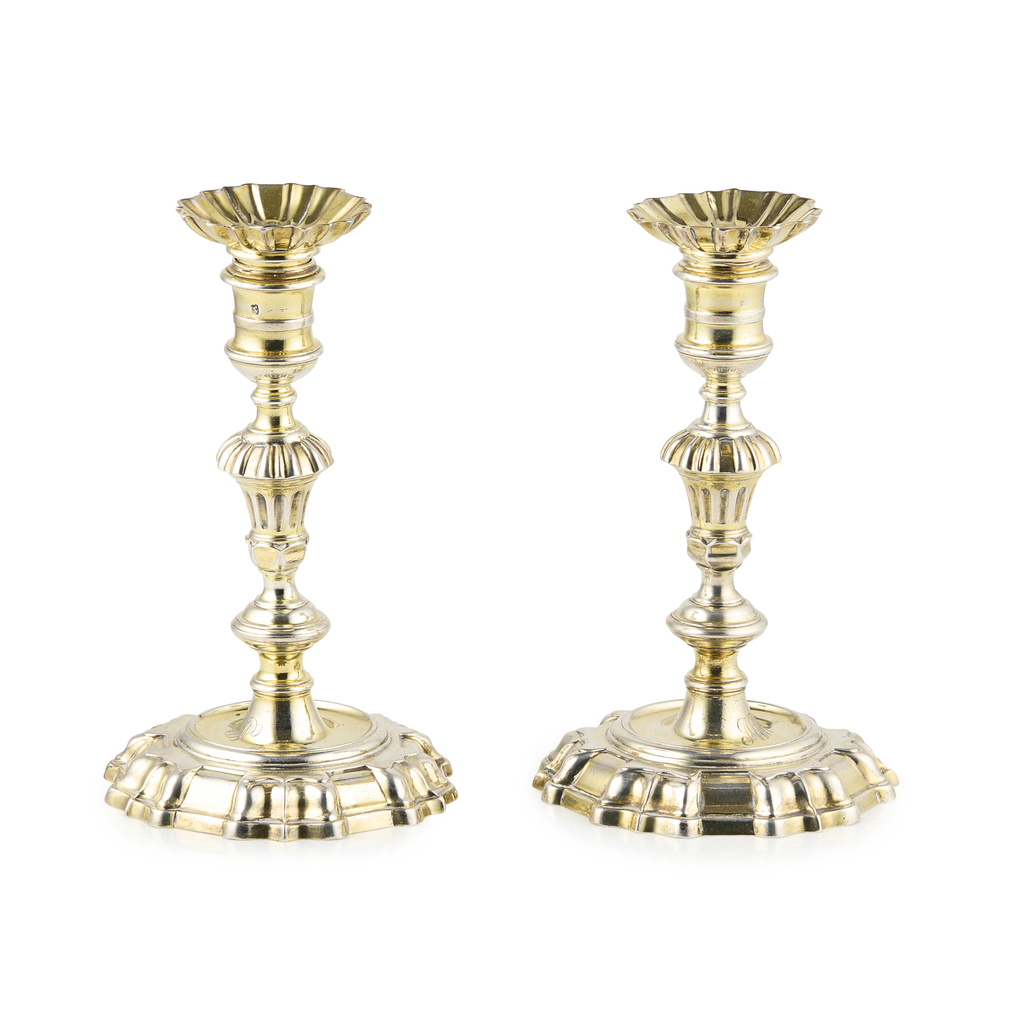A PAIR OF GEORGE II CAST GILT CANDLESTICKS