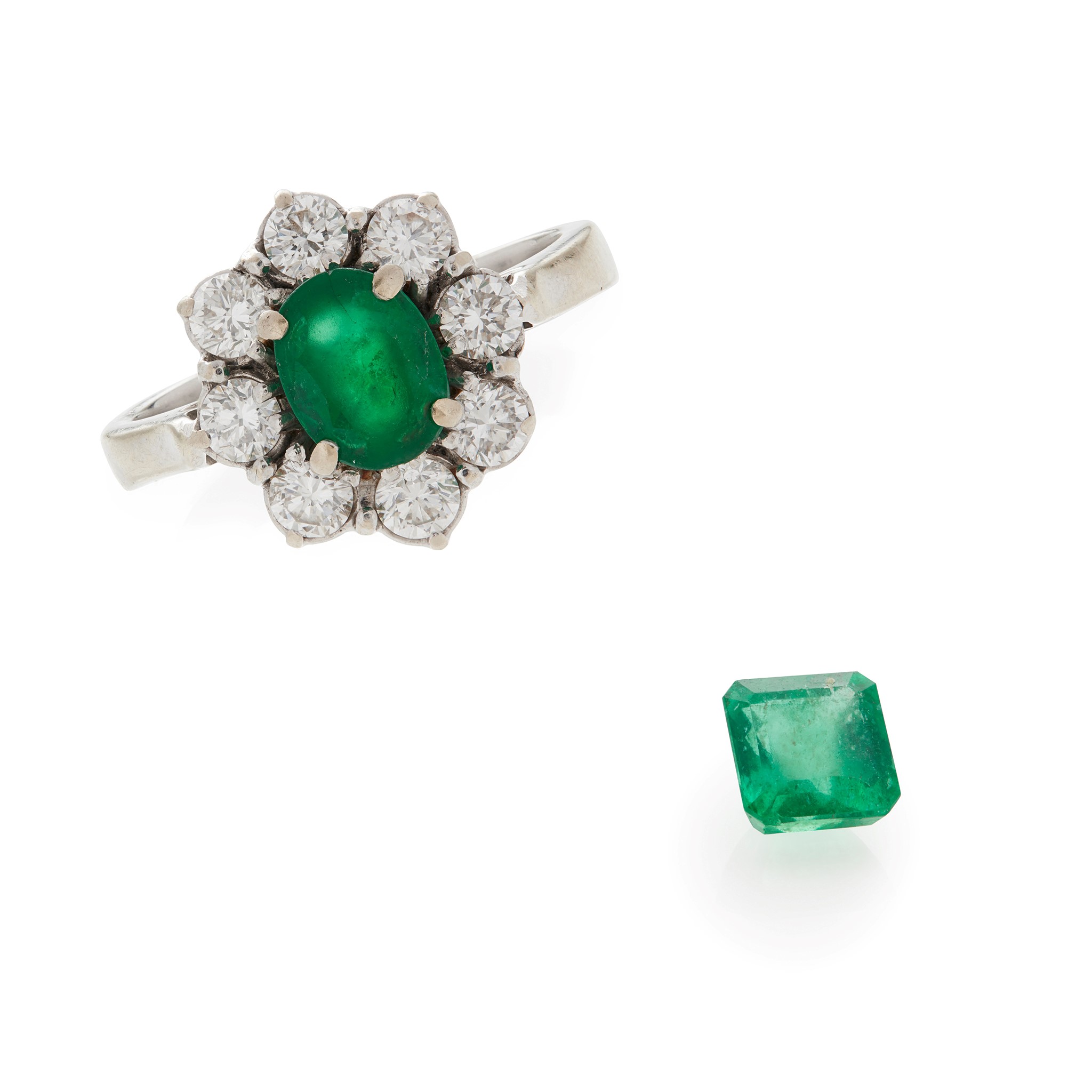 An emerald and diamond set cluster ring