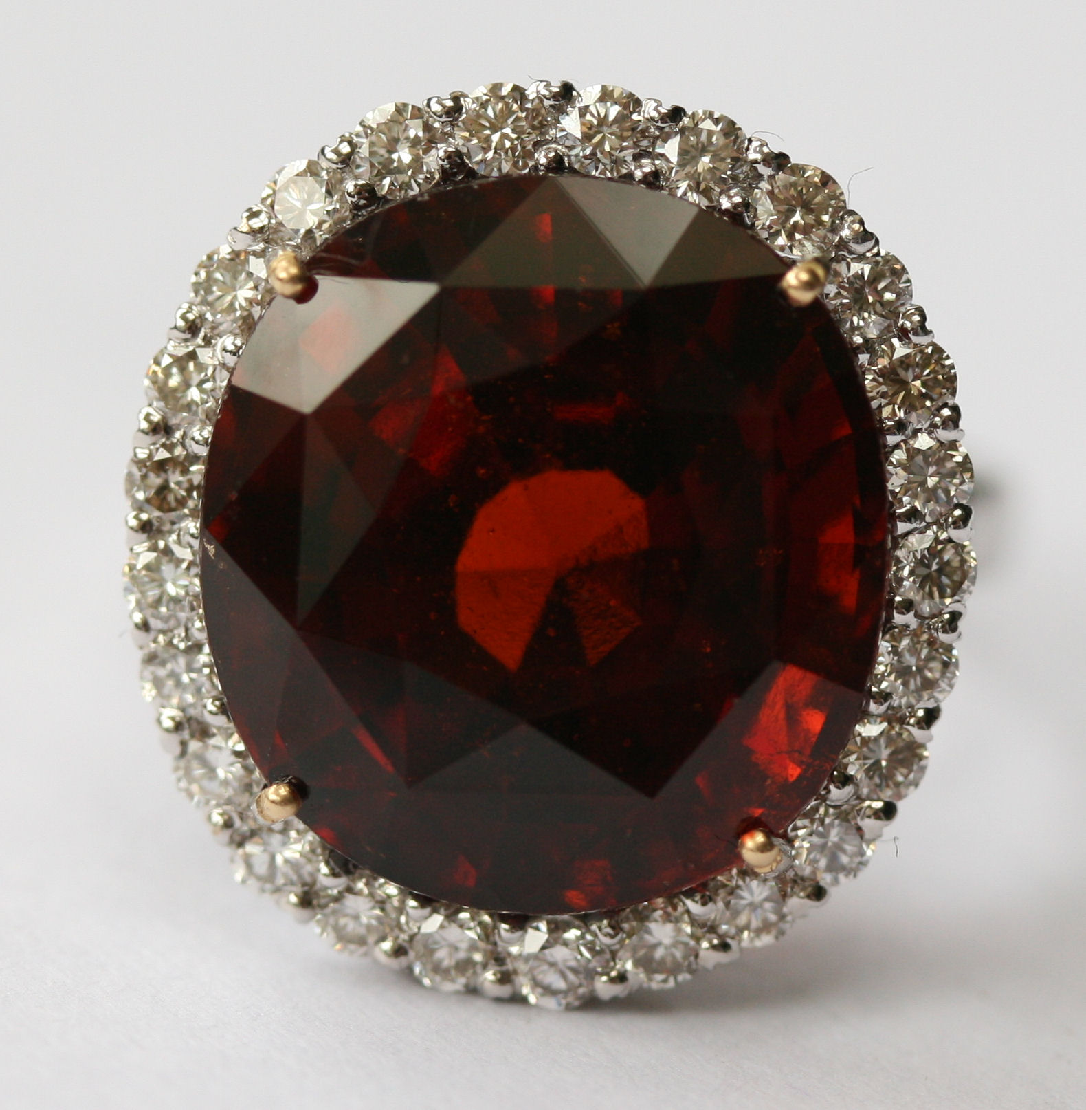 An 18ct white gold mounted garnet and diamond cluster ring
