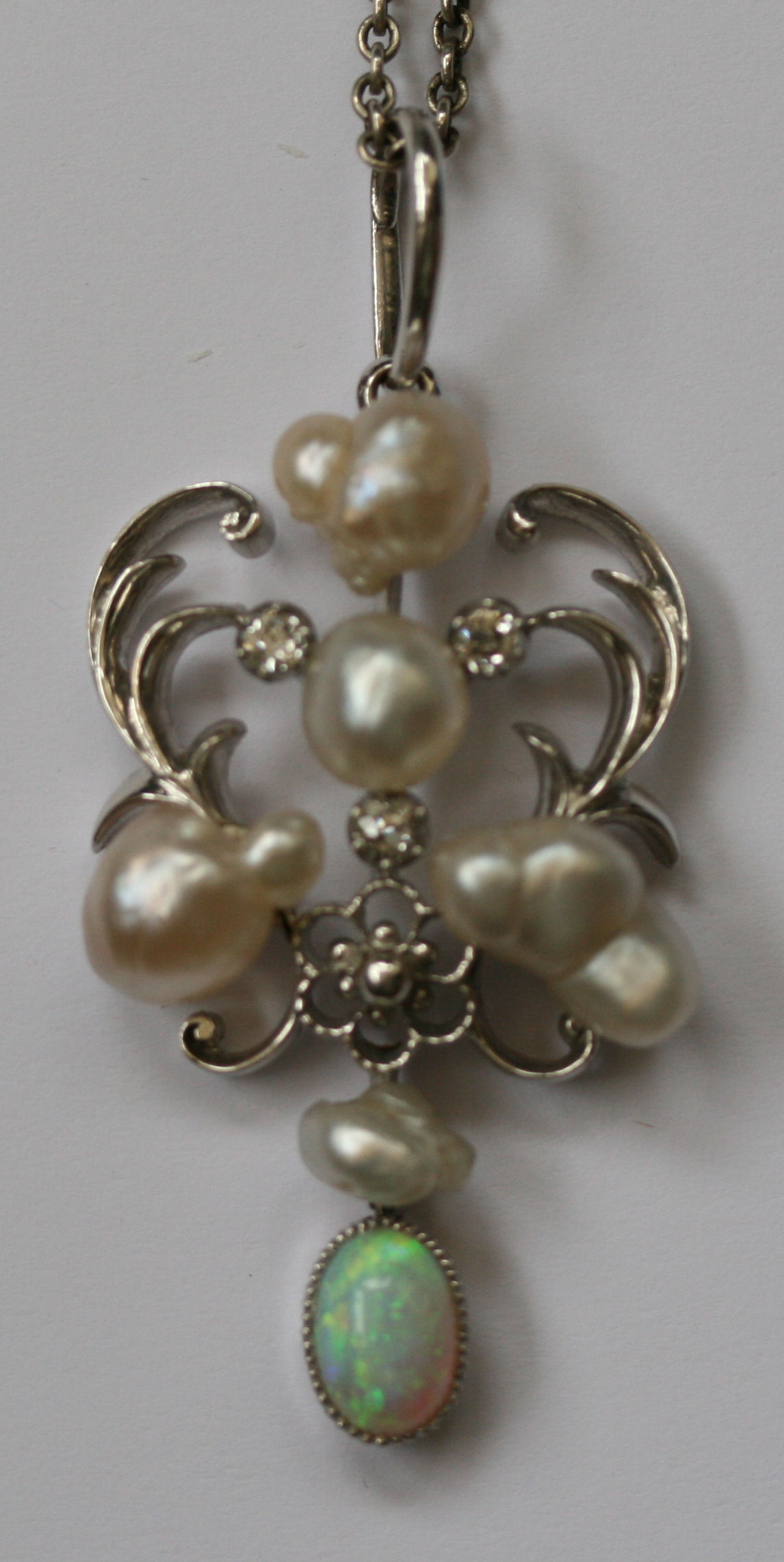 An early 20th century multi-gem set pendant with chain