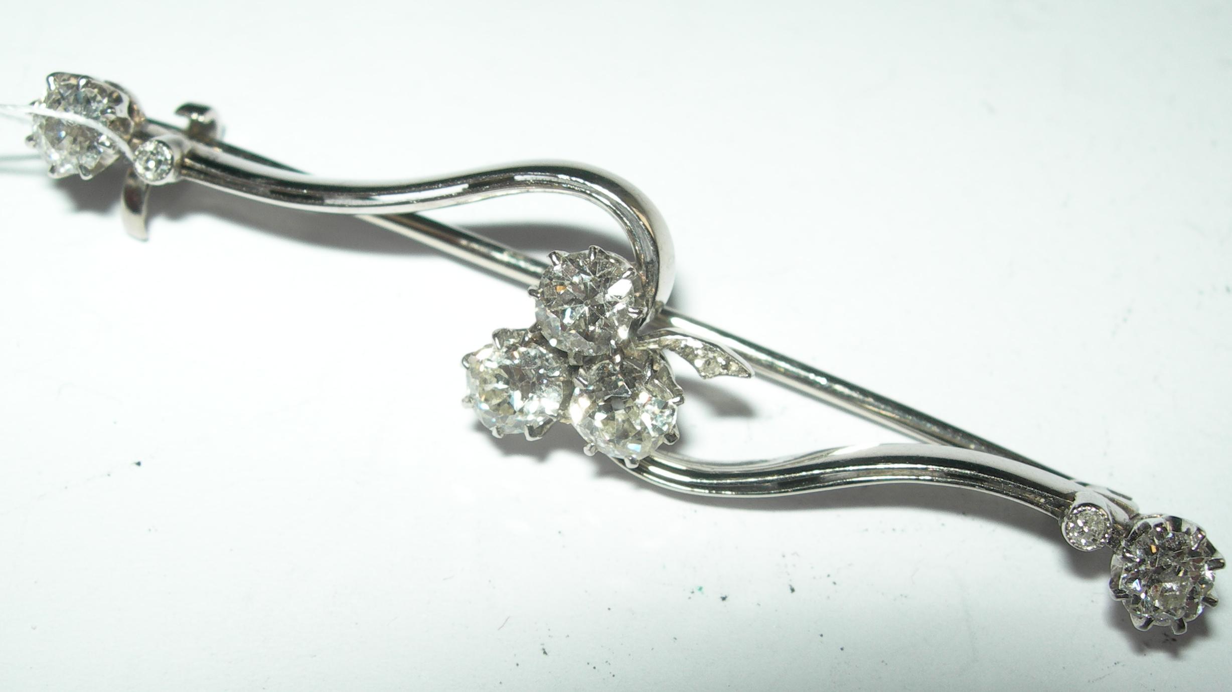 A diamond set bar brooch,