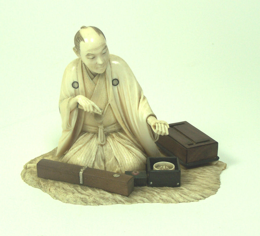 A Japanese ivory okimono of a sword maker, Meiji period