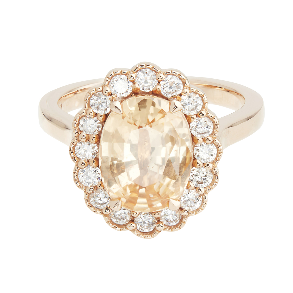 An 18k gold peach sapphire and diamond ring
