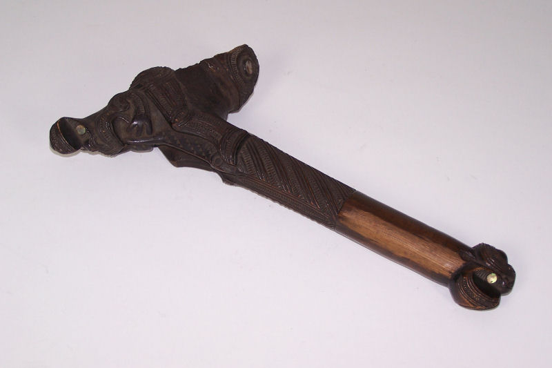 A Maori carved hardwood axe handle