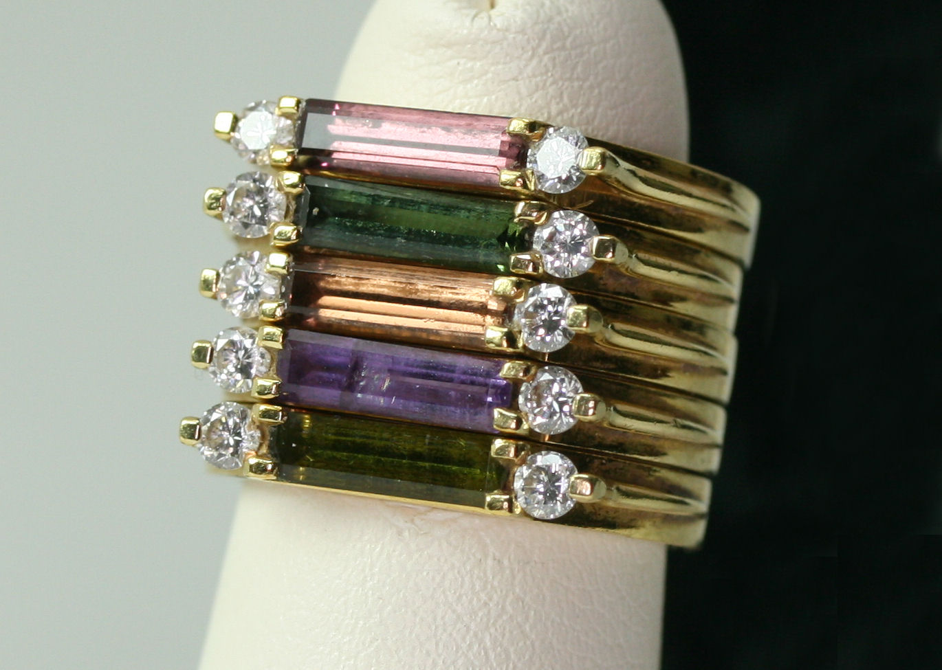 A suite of five assorted diamond and gem set rings
