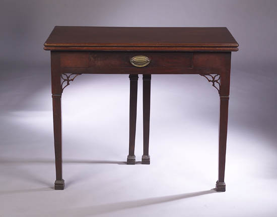 An early 19th century mahogany foldover tea table