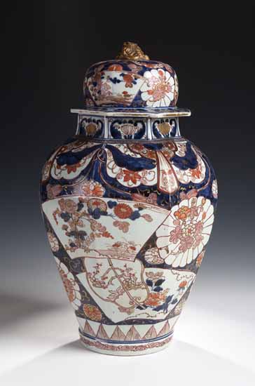 A large Japanese Imari octagonal section baluster vase and cover