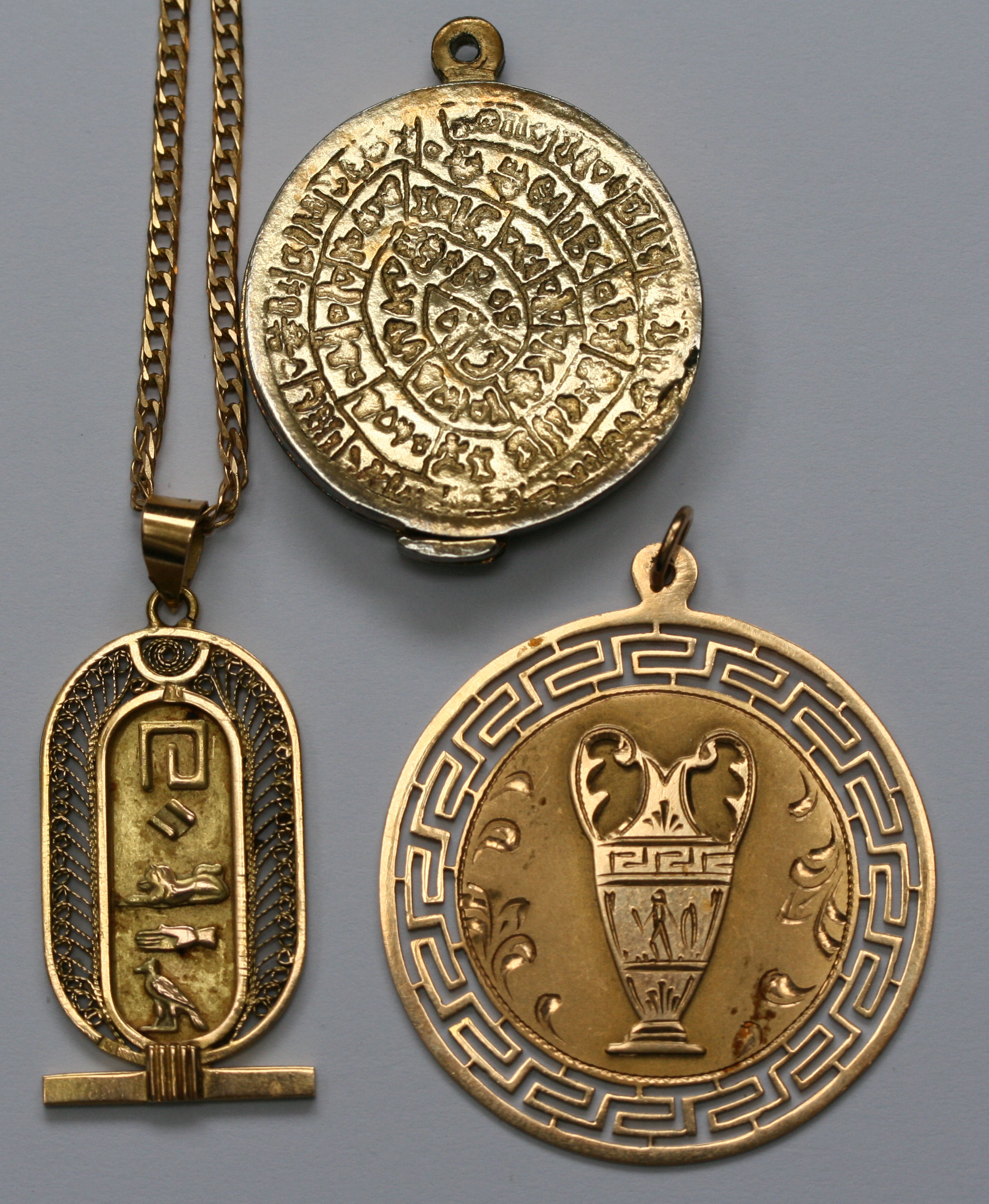 Two gold pendants, a chain and a locket