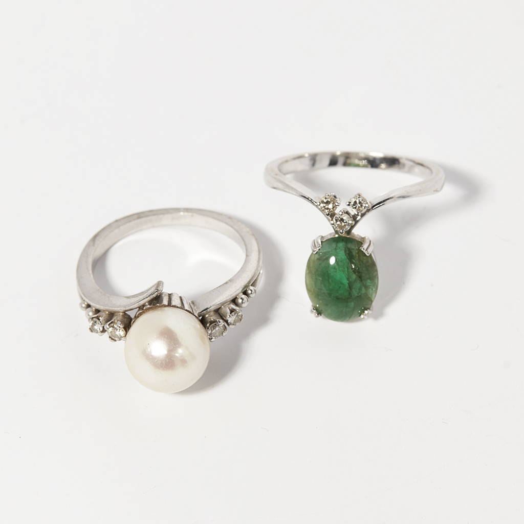 An emerald and diamond set wishbone ring