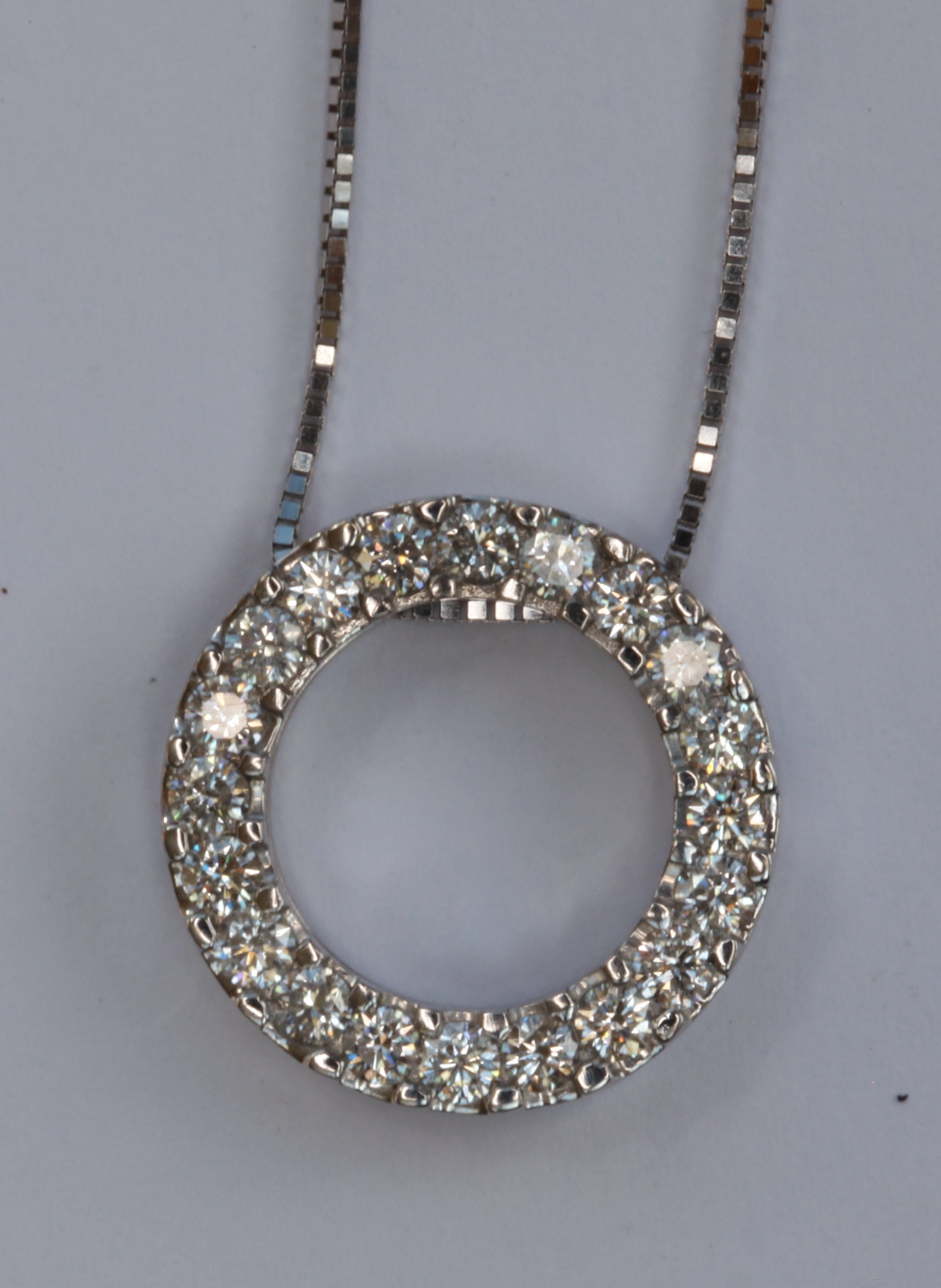 An 18ct white gold mounted diamond set pendant with chain