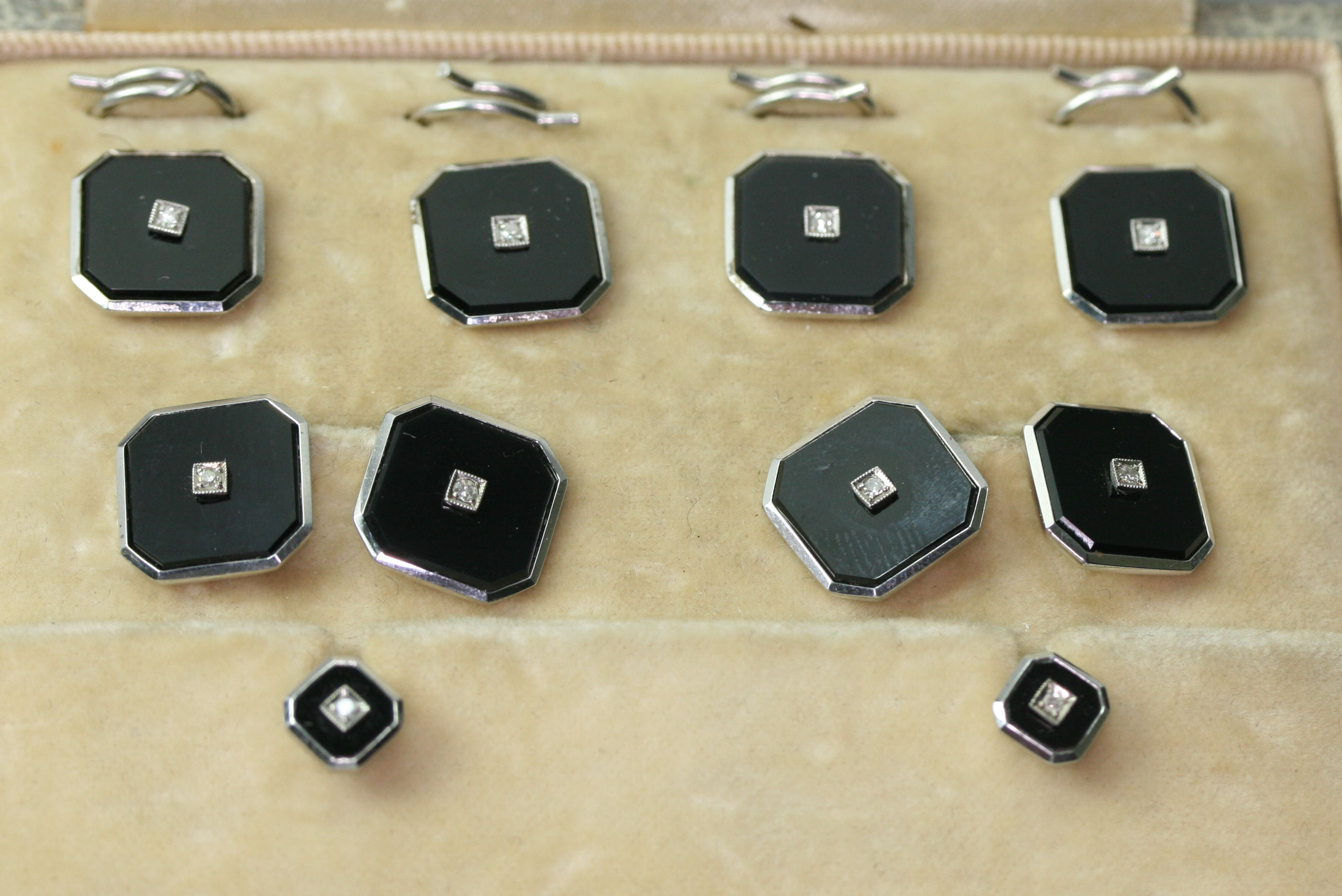 An Edwardian 9ct white gold mounted onyx and diamond gentleman's dress set