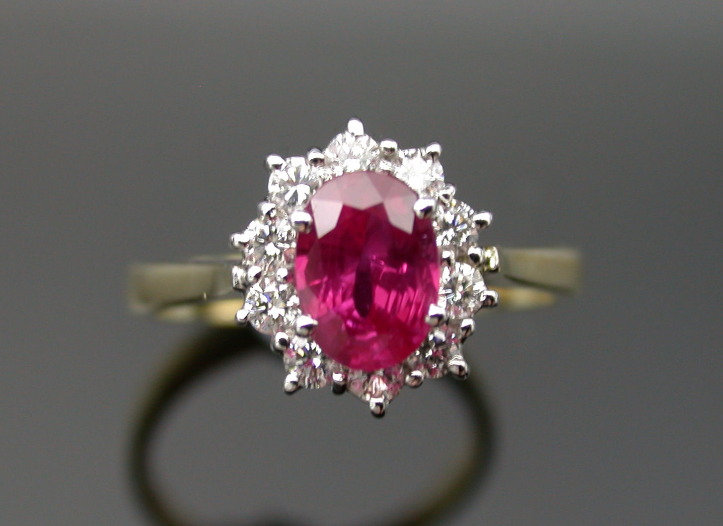 An 18ct gold mounted oval cluster ring,