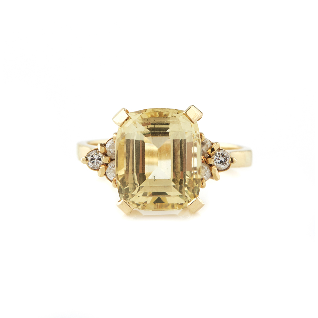 A yellow sapphire and diamond set ring