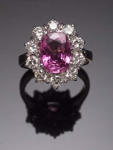 An 18ct gold mounted pink sapphire and diamond cluster ring,