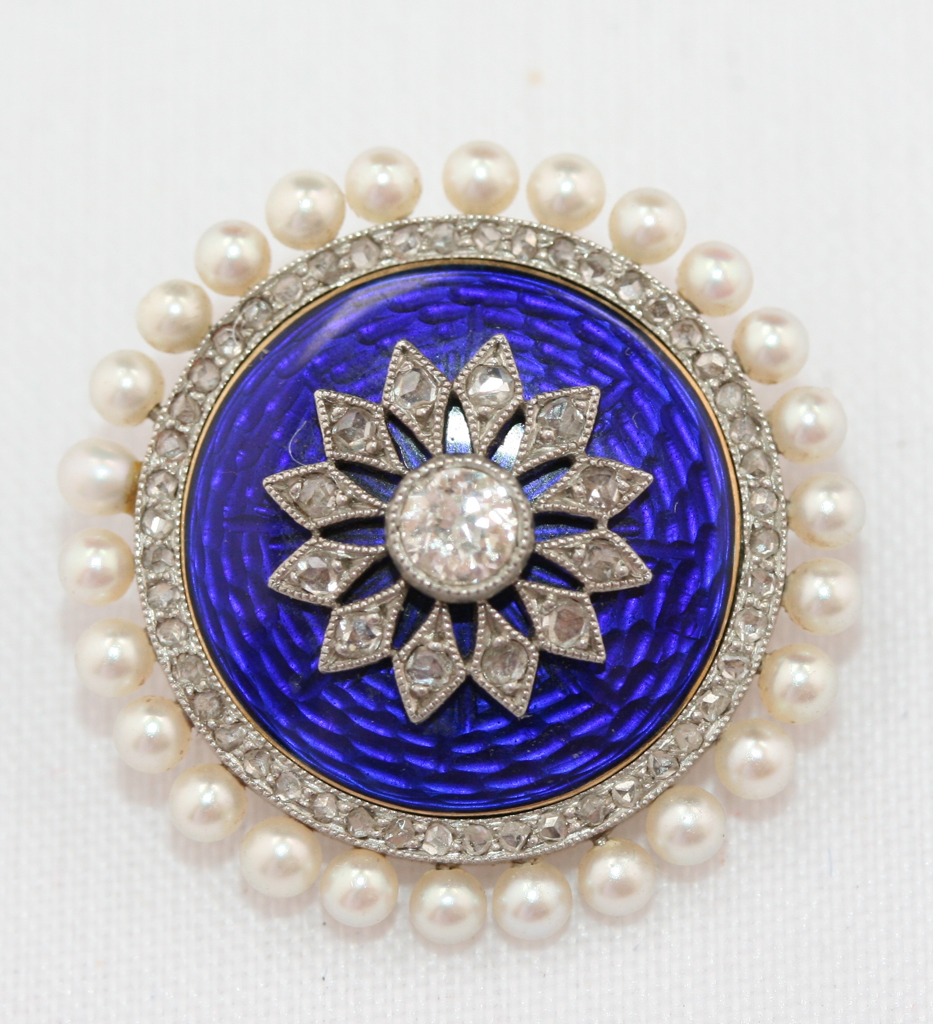An Edwardian enamel, pearl and diamond brooch