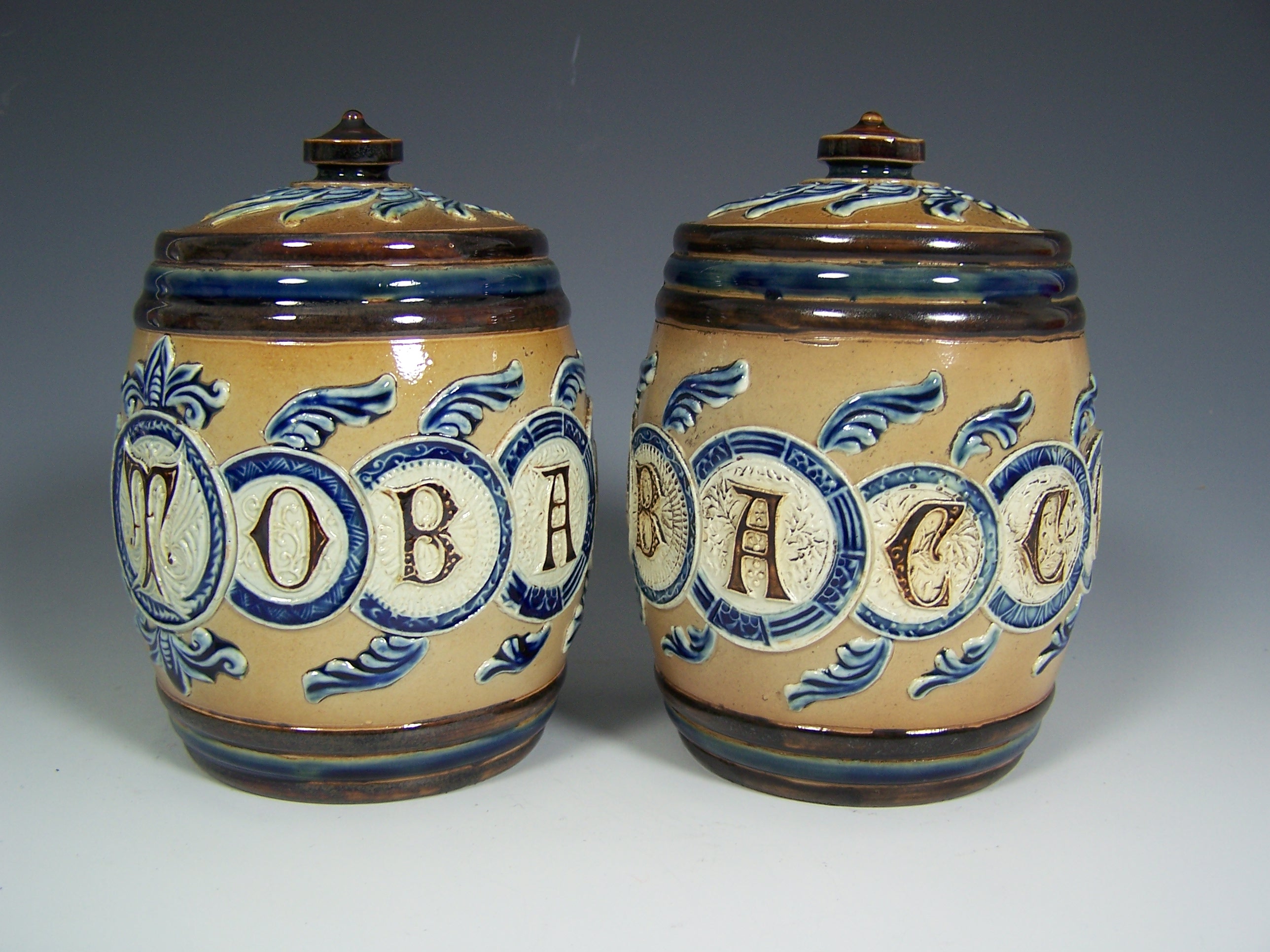 A pair of Doulton Lambeth stoneware tobacco jars and covers