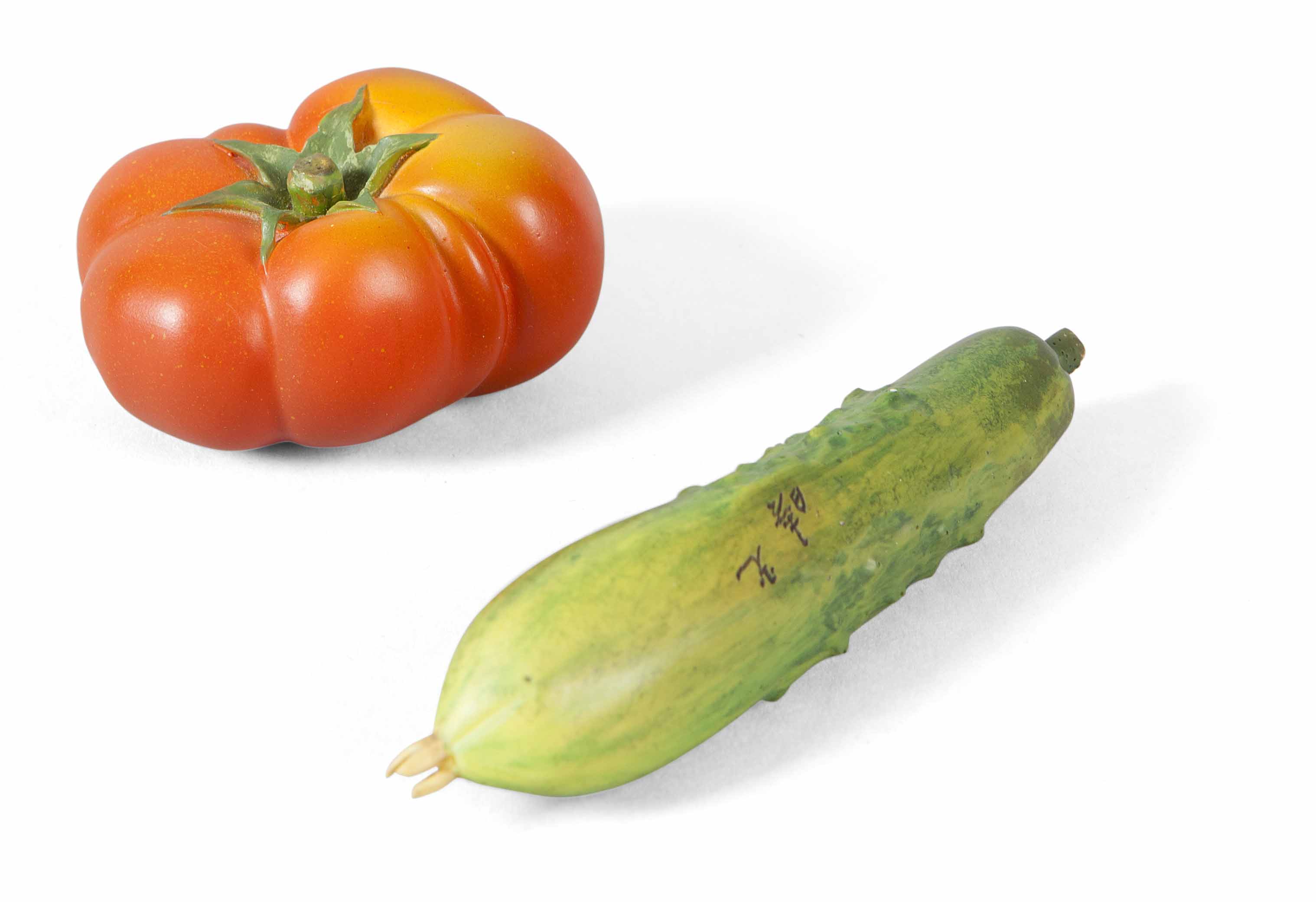 FINE JAPANESE IVORY CARVINGS OF A TOMATO AND A CUCUMBER