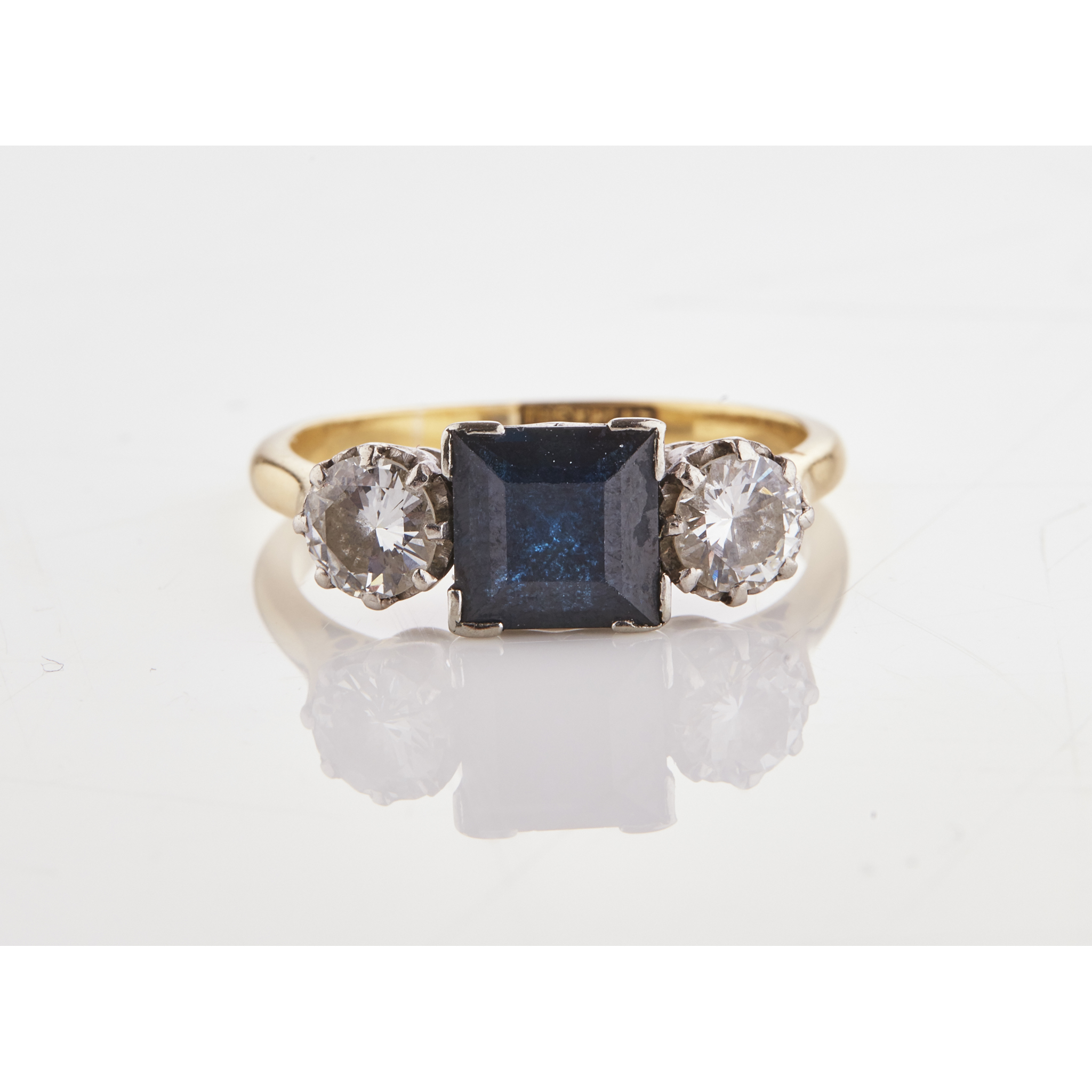 A sapphire and diamond three stone ring