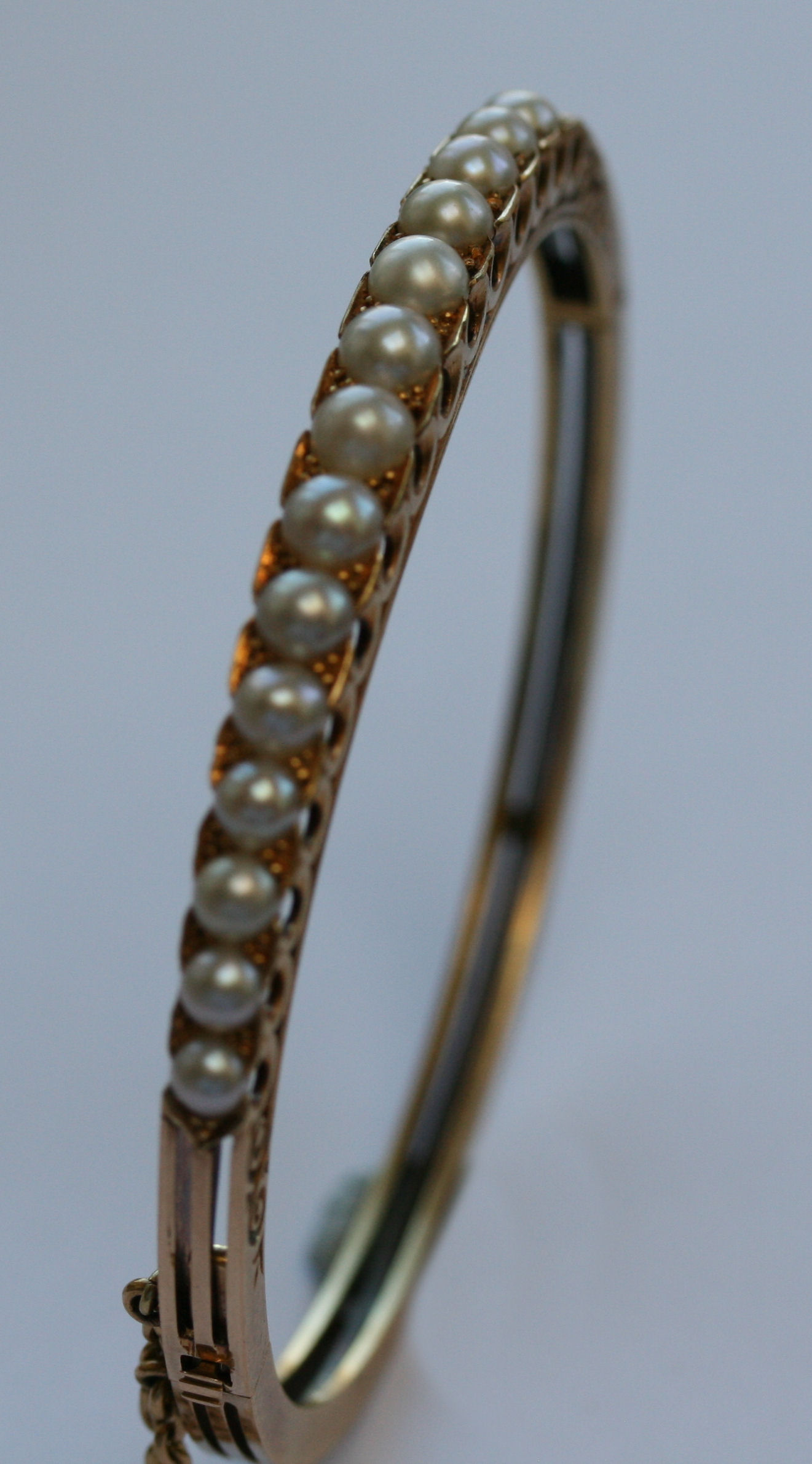 A late Victorian gold and pearl bangle