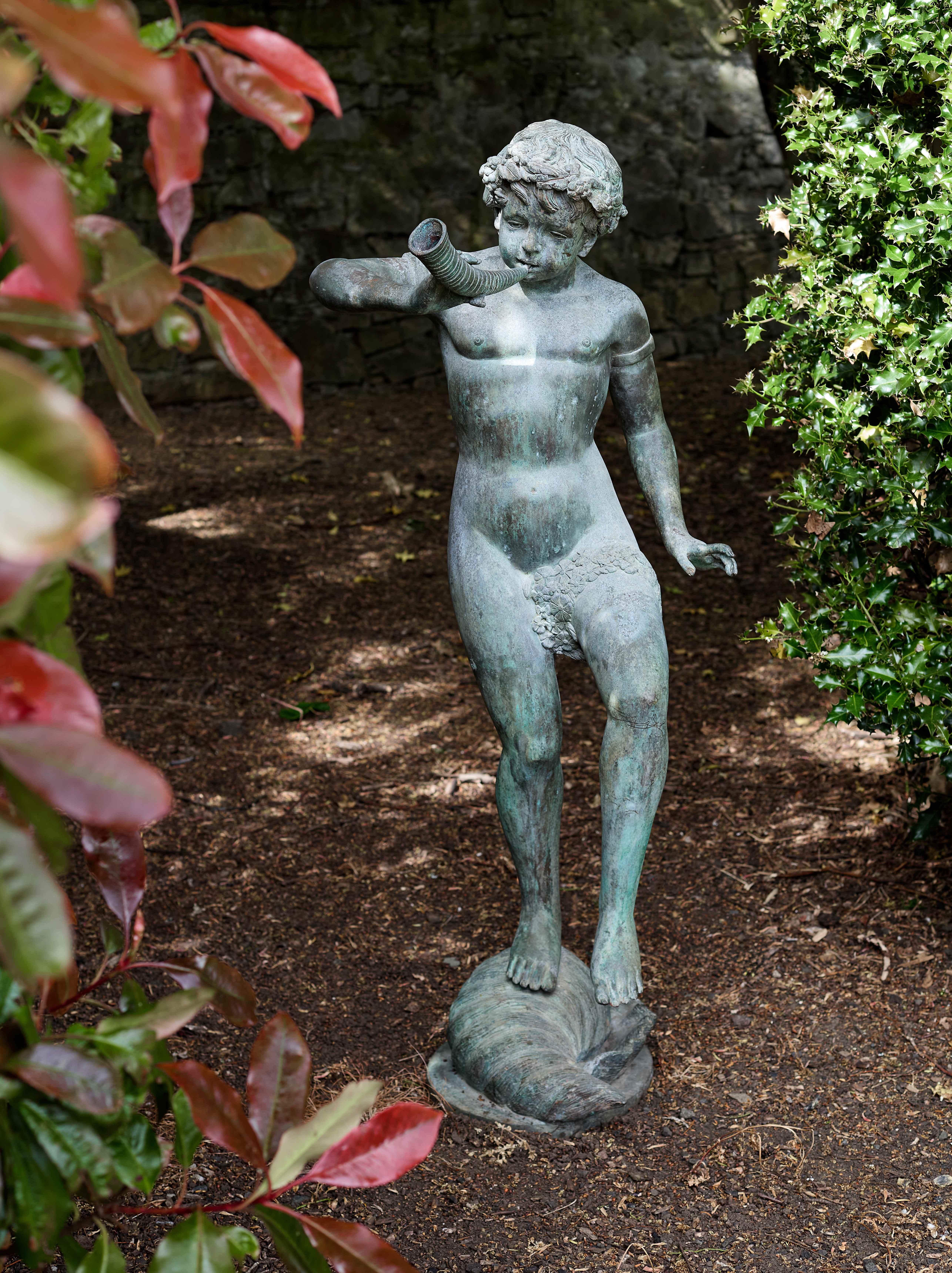 A PATINATED BRONZE FOUNTAIN FIGURE OF THE YOUTH TRITON