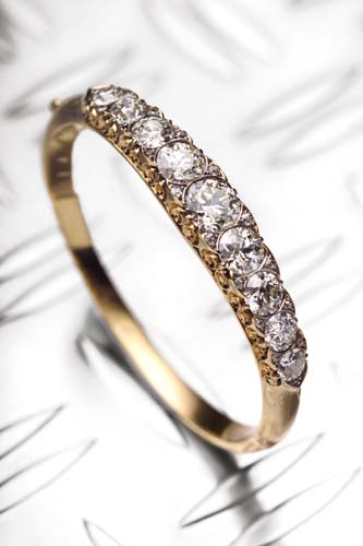 A late Victorian diamond set hinged bangle,