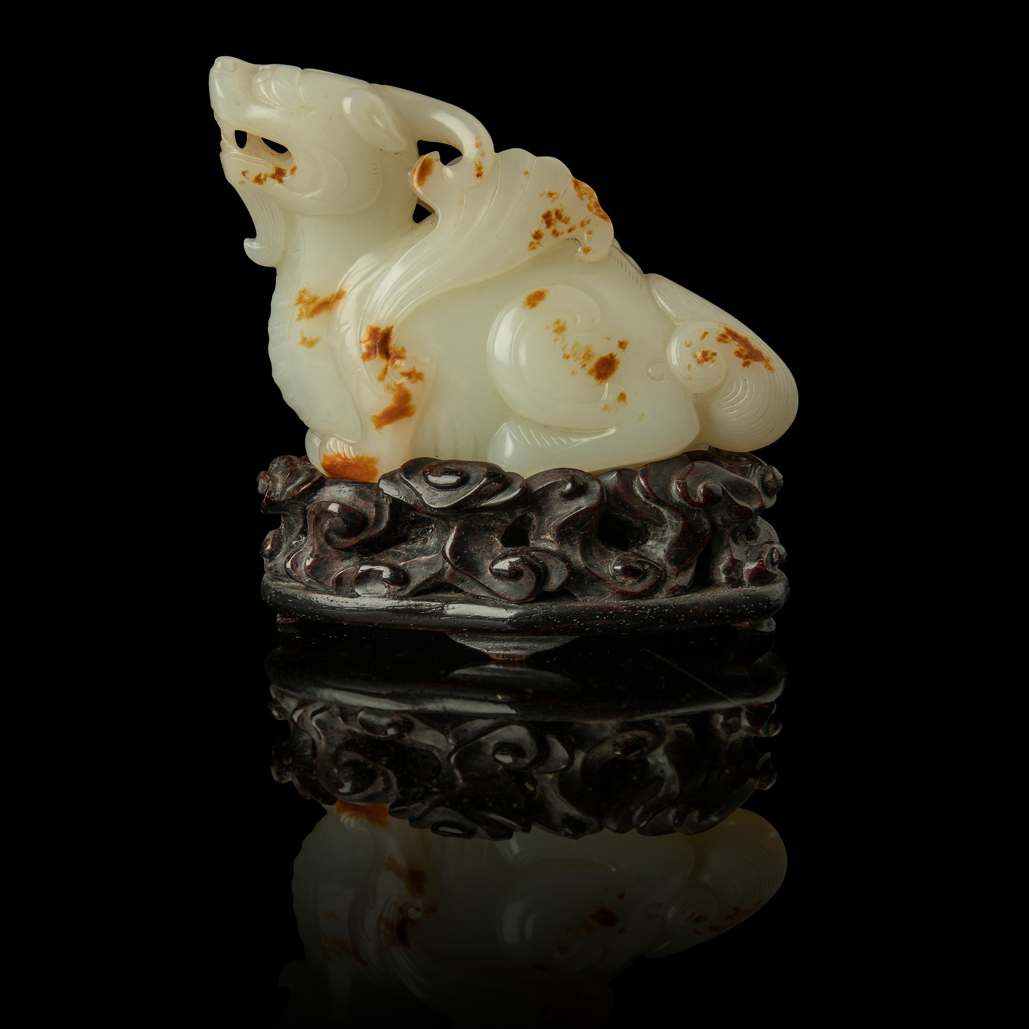 WHITE JADE WITH RUSSET SKIN CARVING OF A MYTHICAL WINGED ANIMAL