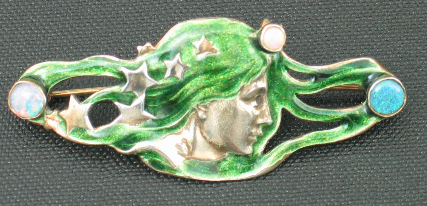 An Art Nouveau silver gilt and enamel brooch,