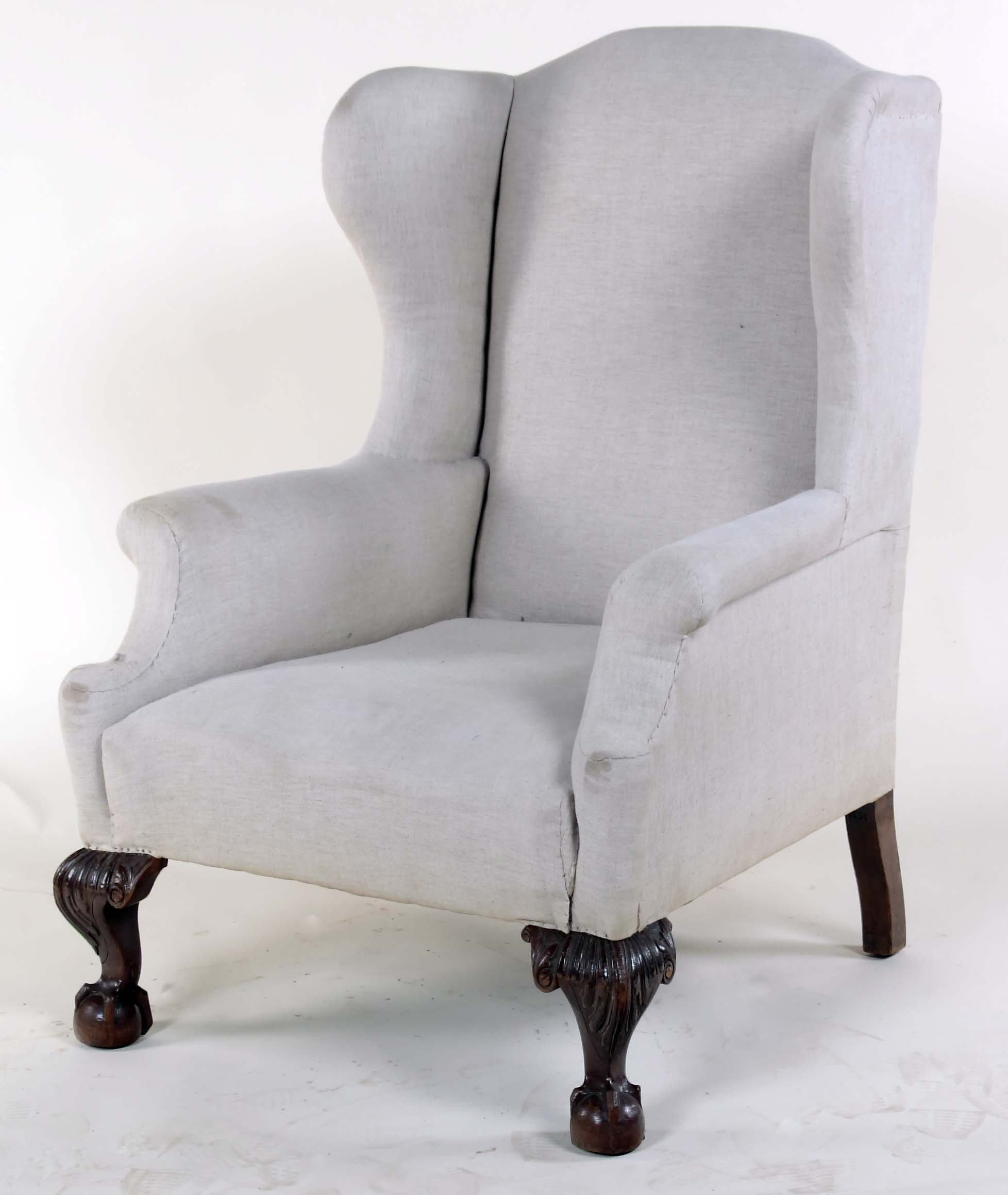 An early 19th century wing back armchair