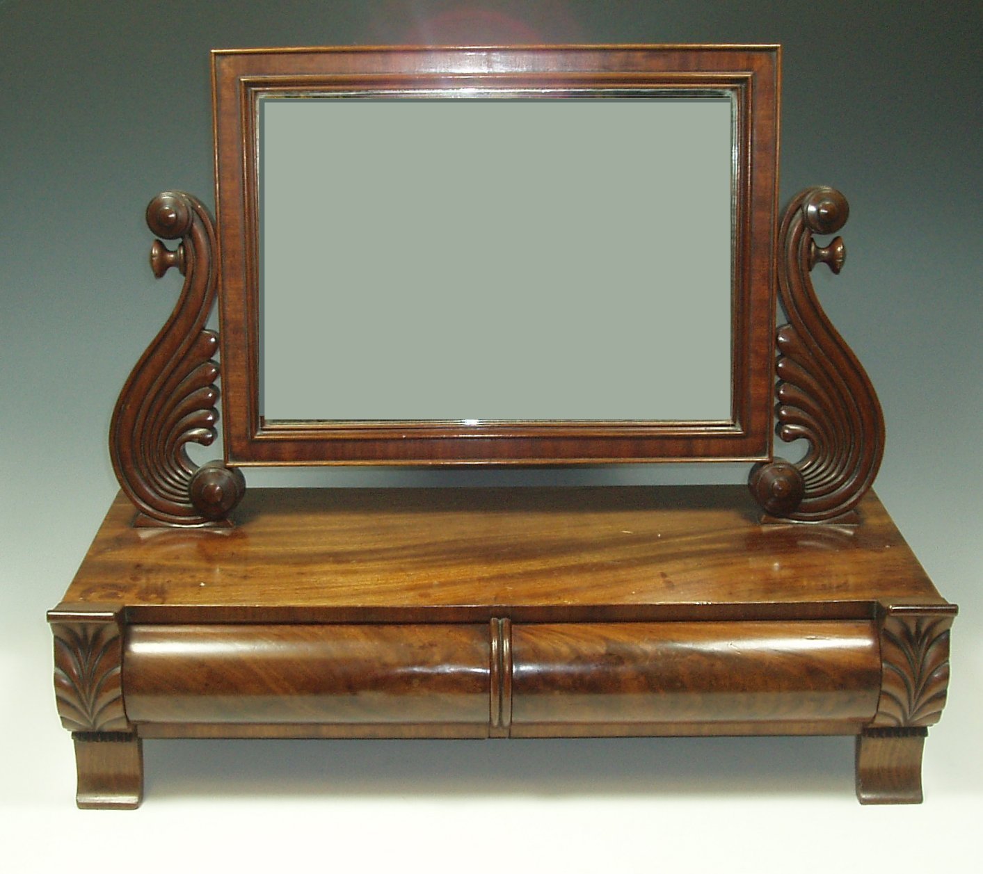 An early 19th century mahogany dressing mirror,