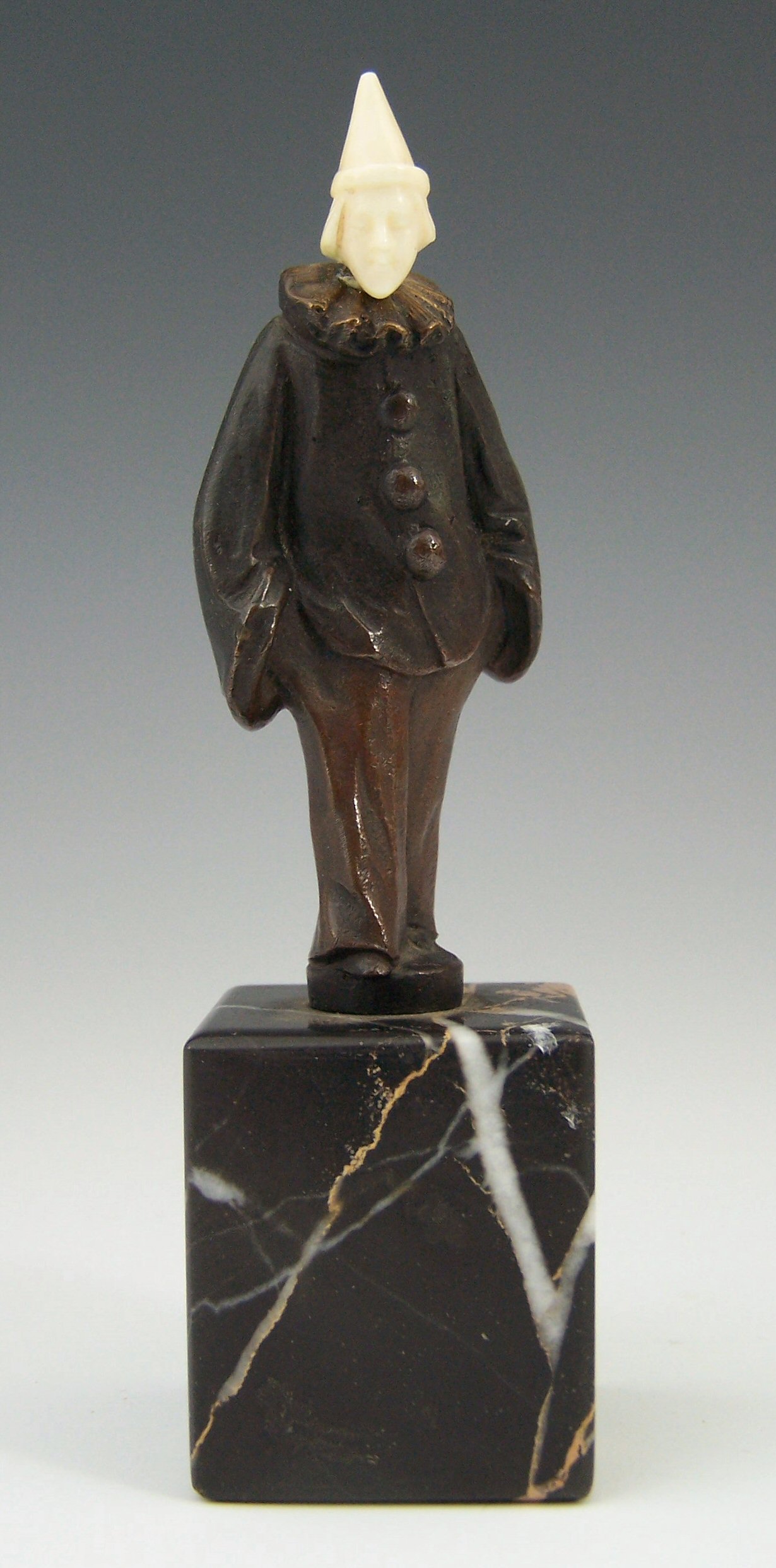 An Art Deco bronze and ivory figure of pierrot,