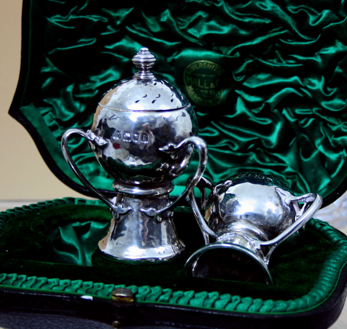 A cased pair of silver condiments