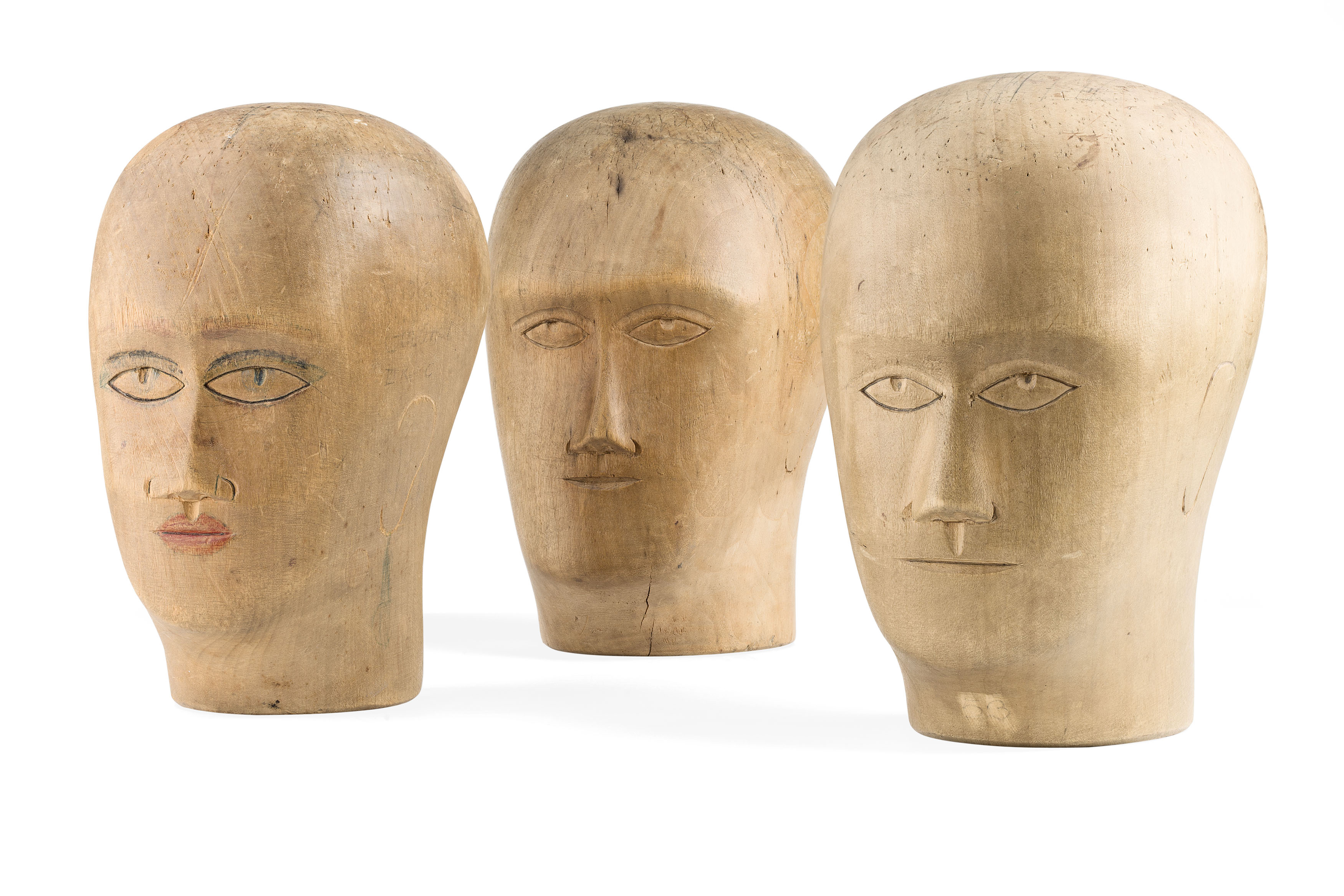 THREE CARVED WOODEN MILLINERY HEADS