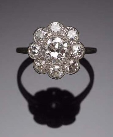 A platinum mounted diamond floral cluster ring,