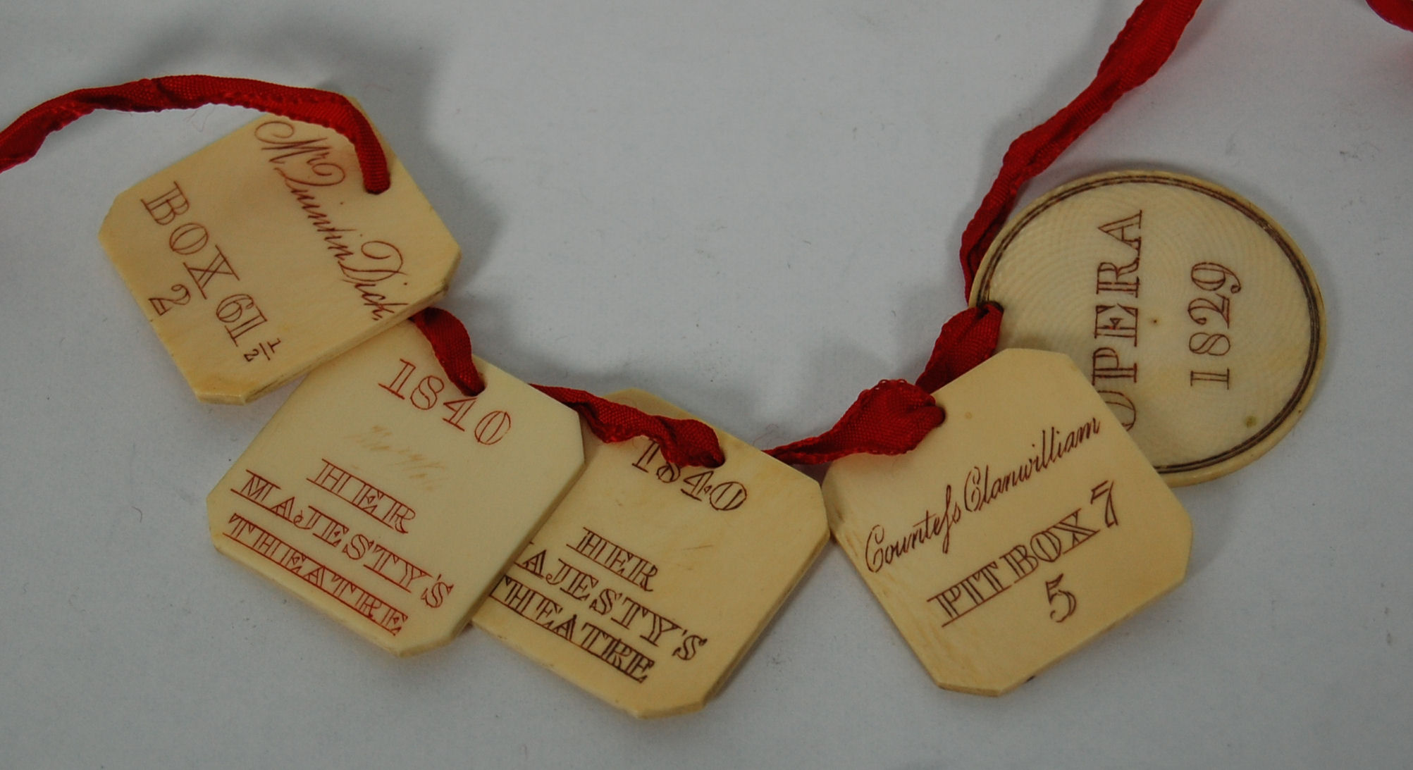 A collection of five ivory opera passes