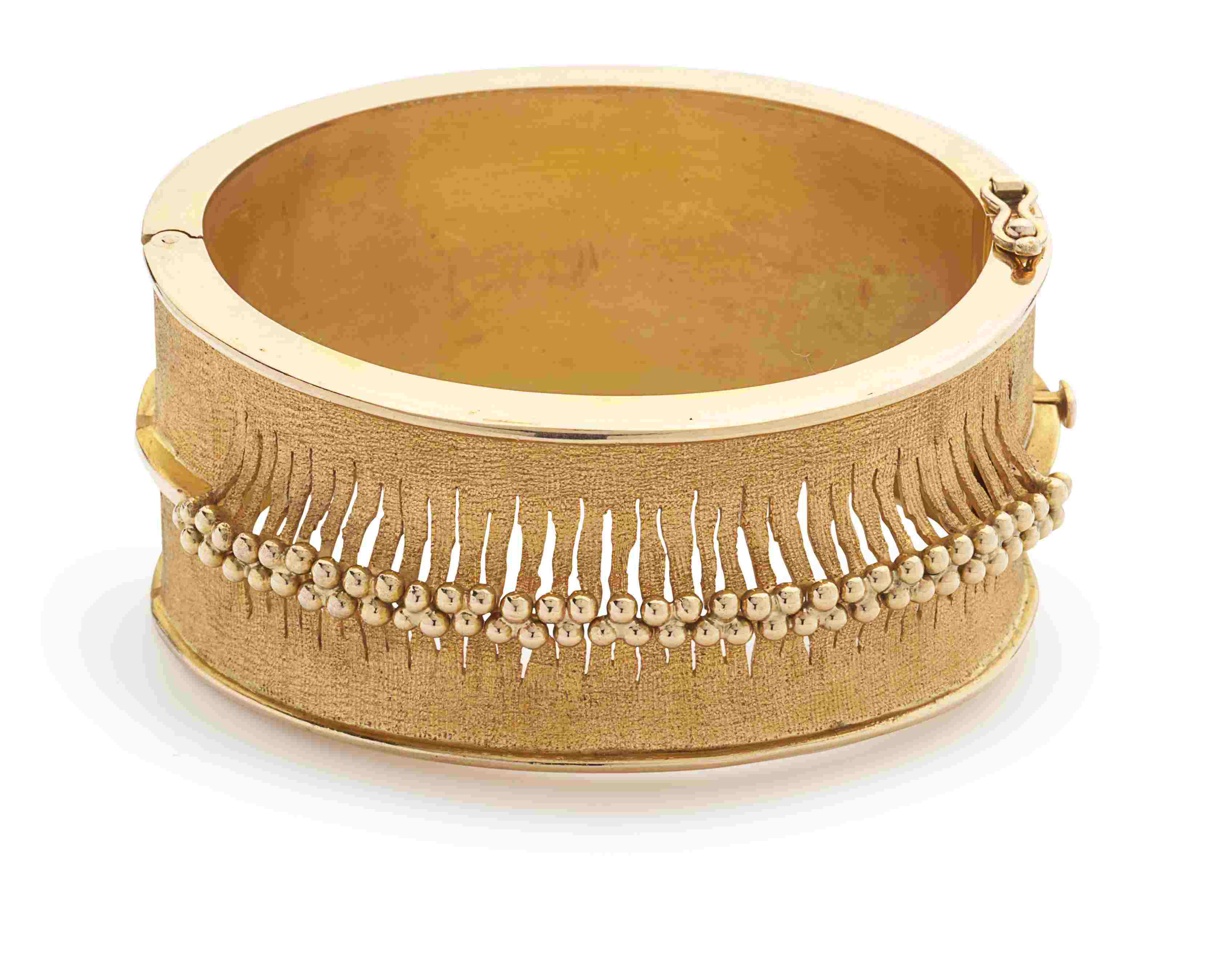 A yellow metal bangle
