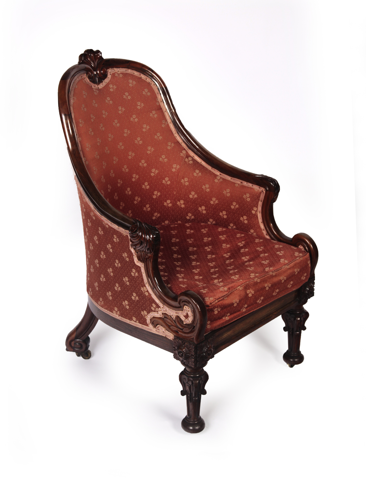 ORNATELY CARVED WILLIAM IV MAHOGANY AND ROSEWOOD TUB BACK BERGERE ARMCHAIR
