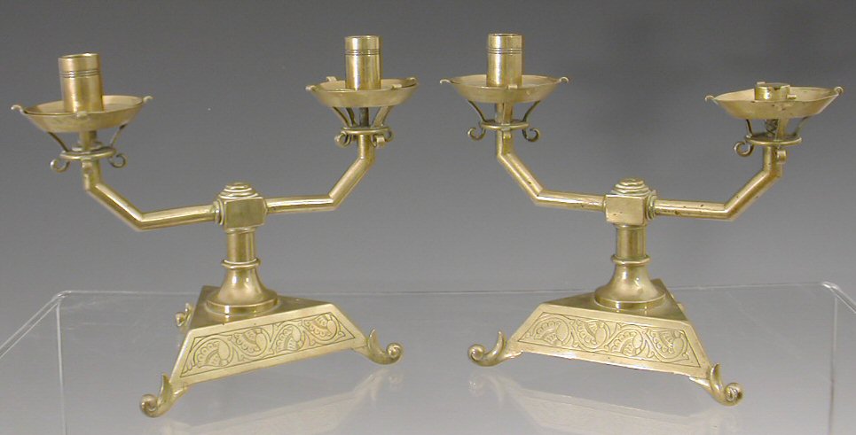 A pair of Aesthetic movement brass candlesticks,