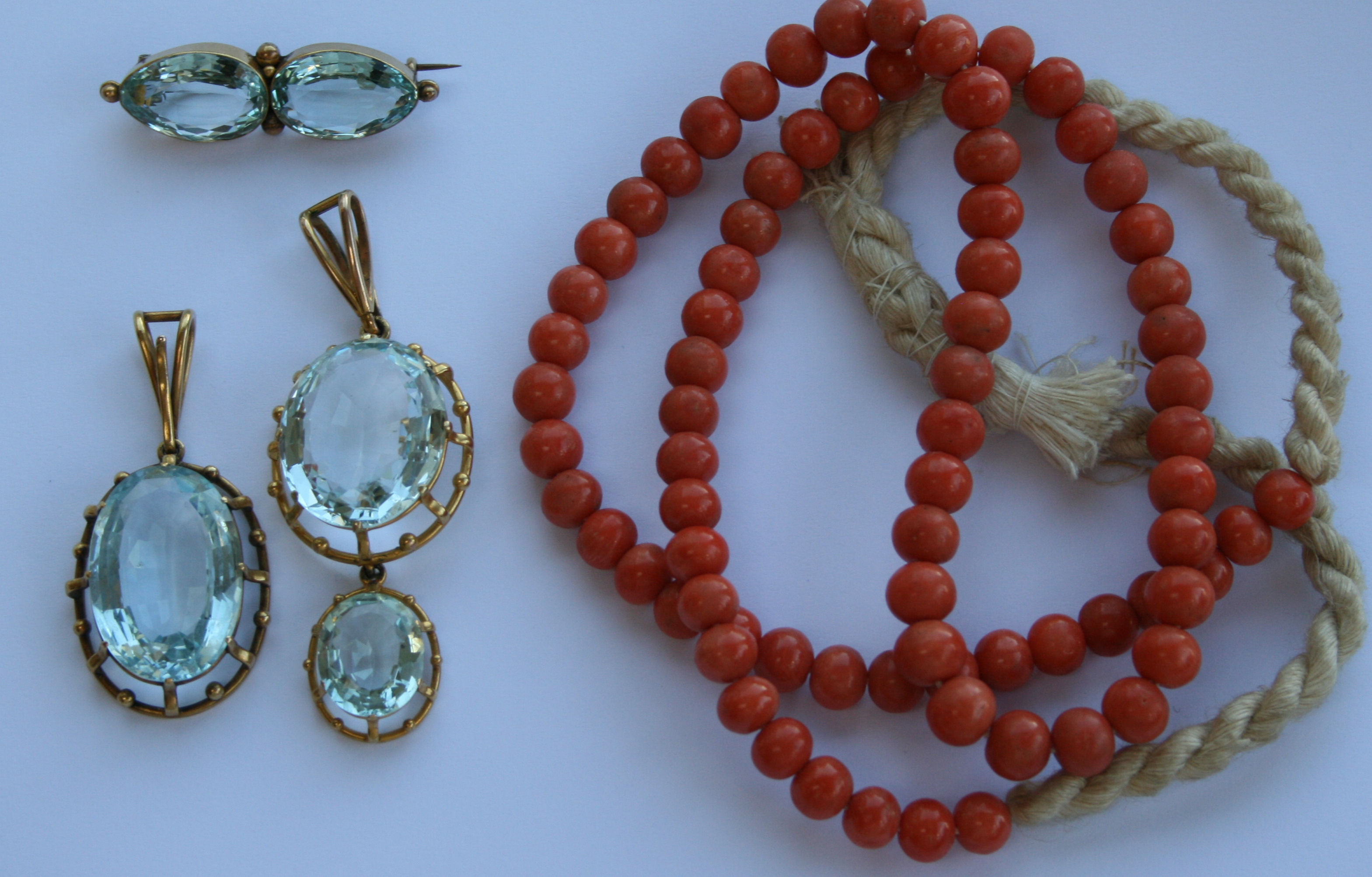 Two aquamarine pendants and a brooch