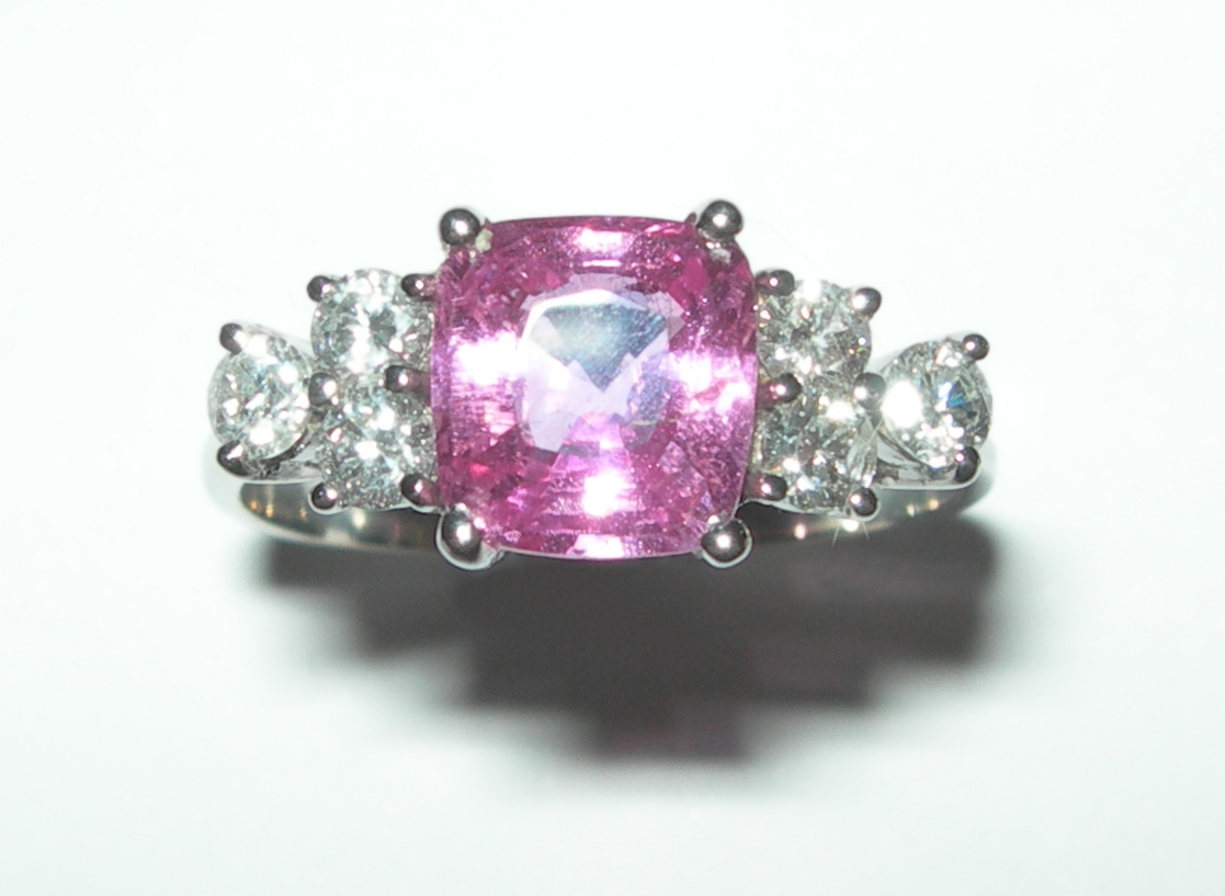 A modern pink sapphire and diamond set ring,