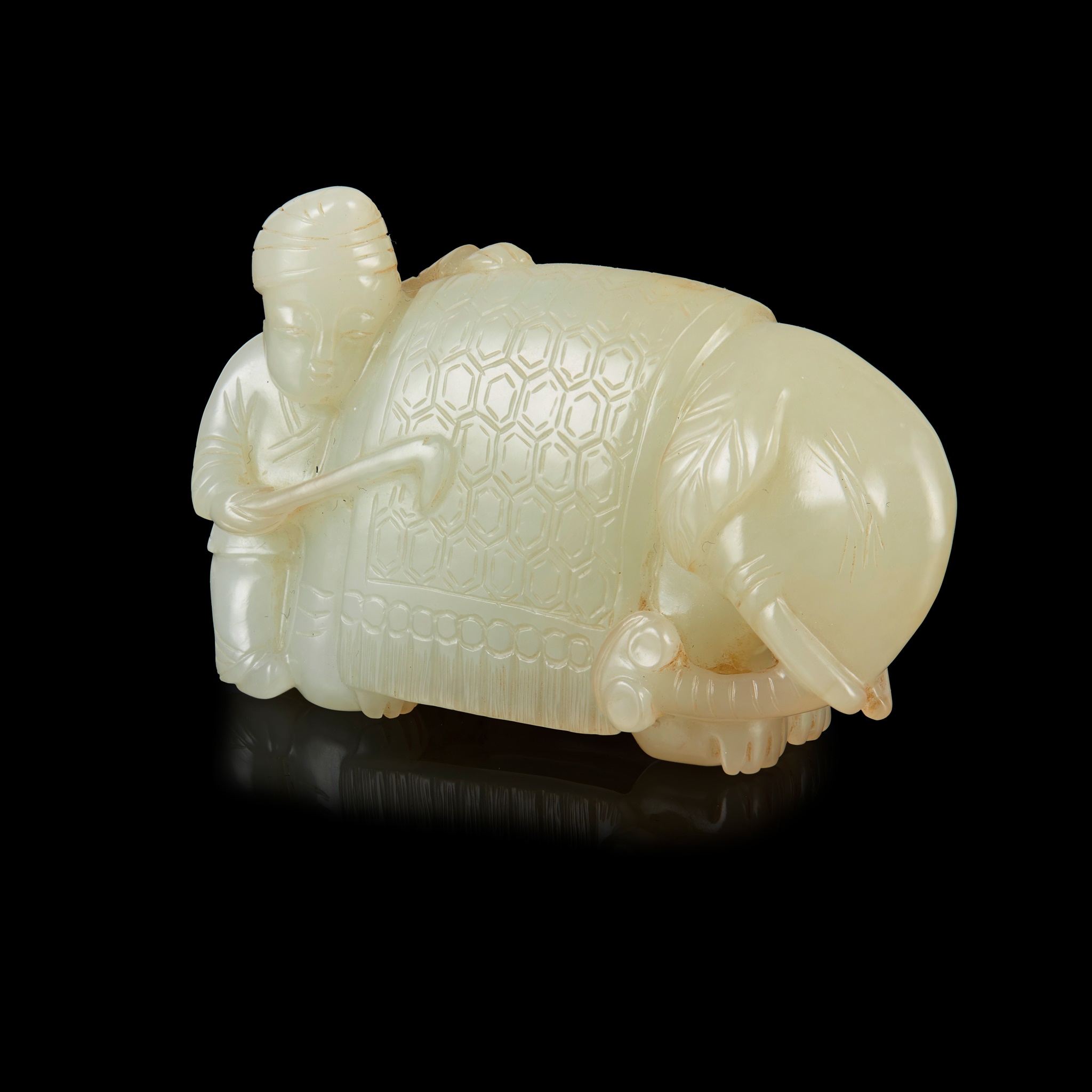 PALE CELADON JADE CARVING OF A BARBARIAN AND ELEPHANT