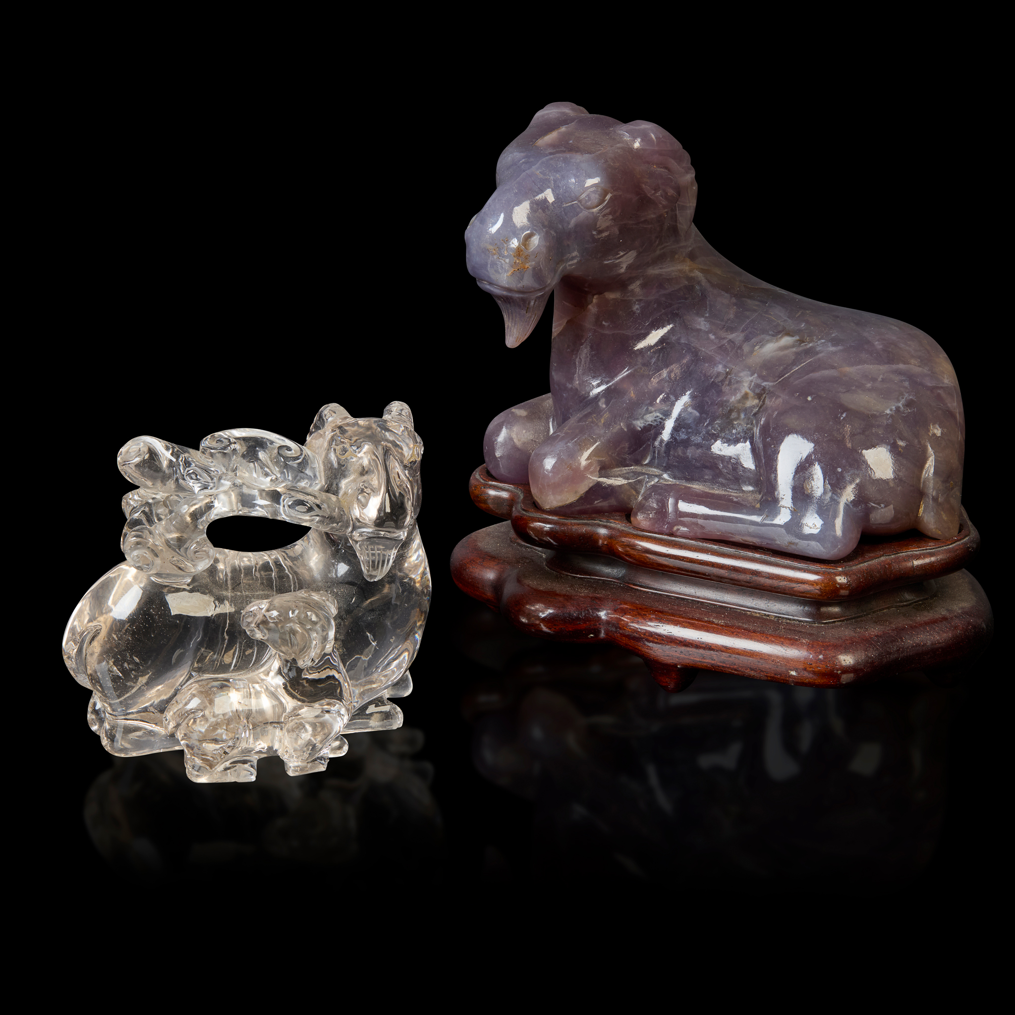 A CHINESE PURPLE QUARTZ AND A ROCK CRYSTAL ANIMAL CARVINGS